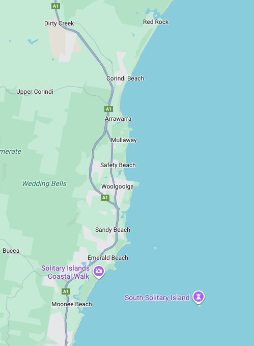 Map showing coastal towns and beaches along the A1 highway near South Solitary Island, including Corindi Beach, Red Rock, Arrawarra, Mullaway, Safety Beach, Woolgoolga, Sandy Beach, Emerald Beach, and Moonee Beach, with symbols for transportation and landmarks.