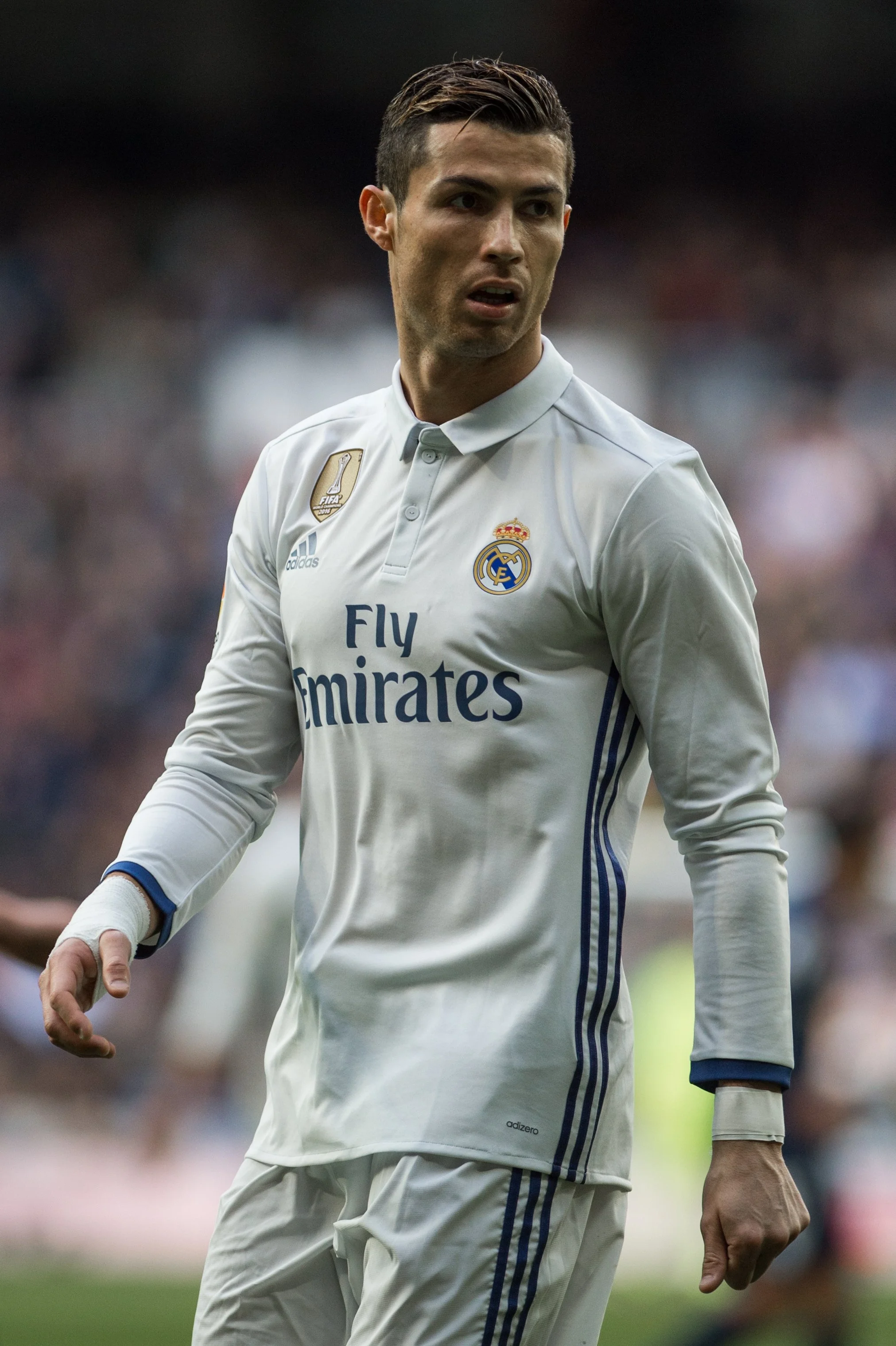 A football player wearing a white Real Madrid jersey during a match.