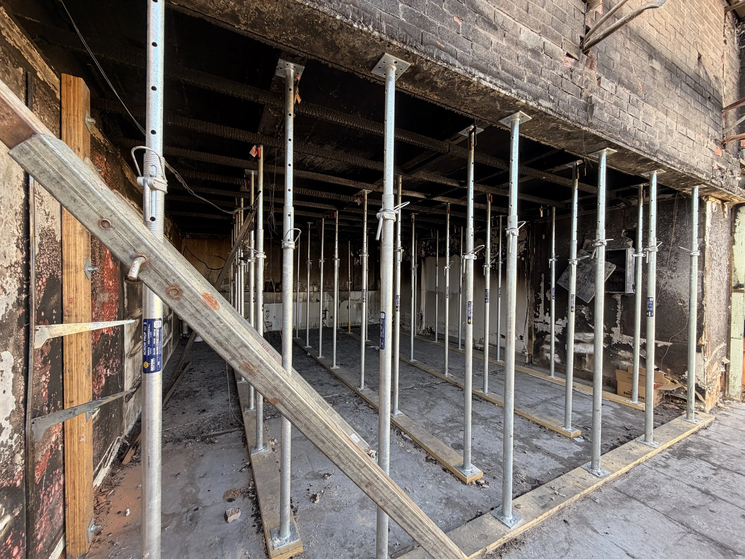 Construction site with steel scaffolding inside a building.