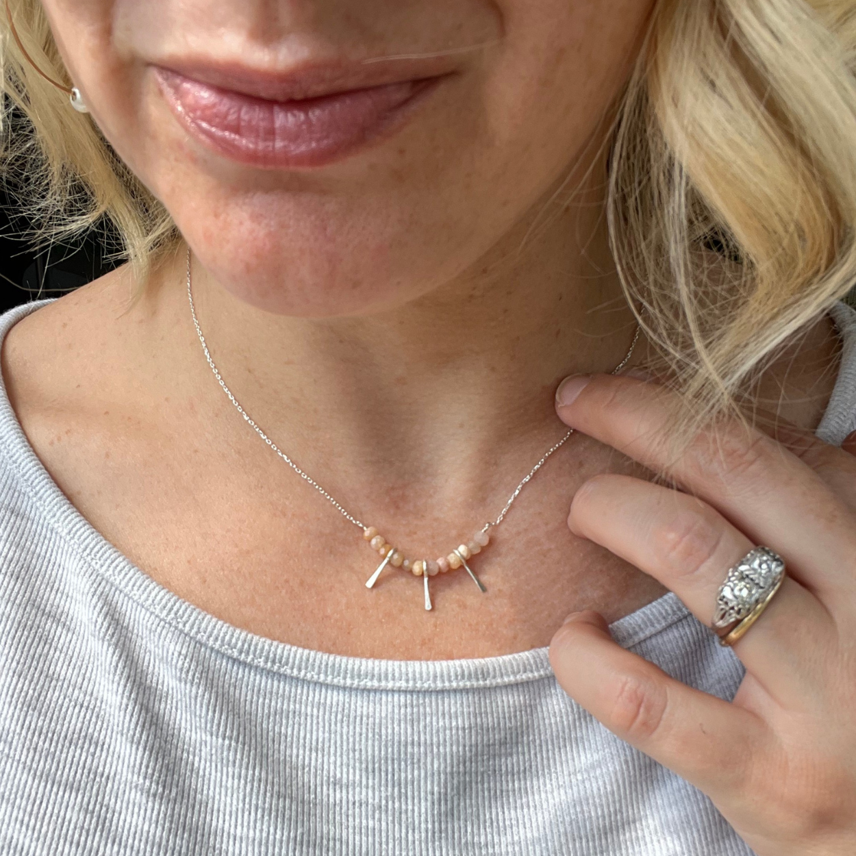woman wearing the Fire + Fringe necklace showing how delicate and dainty it is.