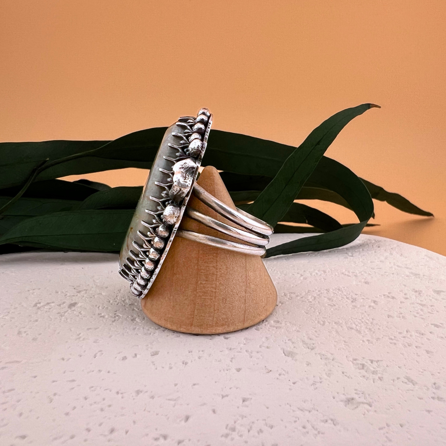 Side view of a Royston ribbon turquoise ring set in sterling silver with hand-made silver nugget accents.