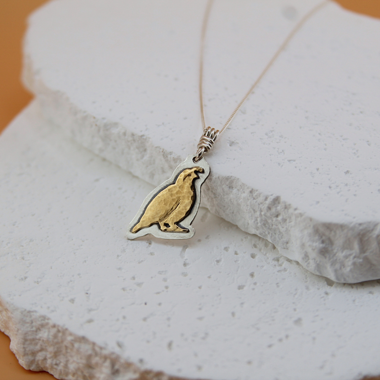 Heritage Quail necklace in brass and sterling silver.