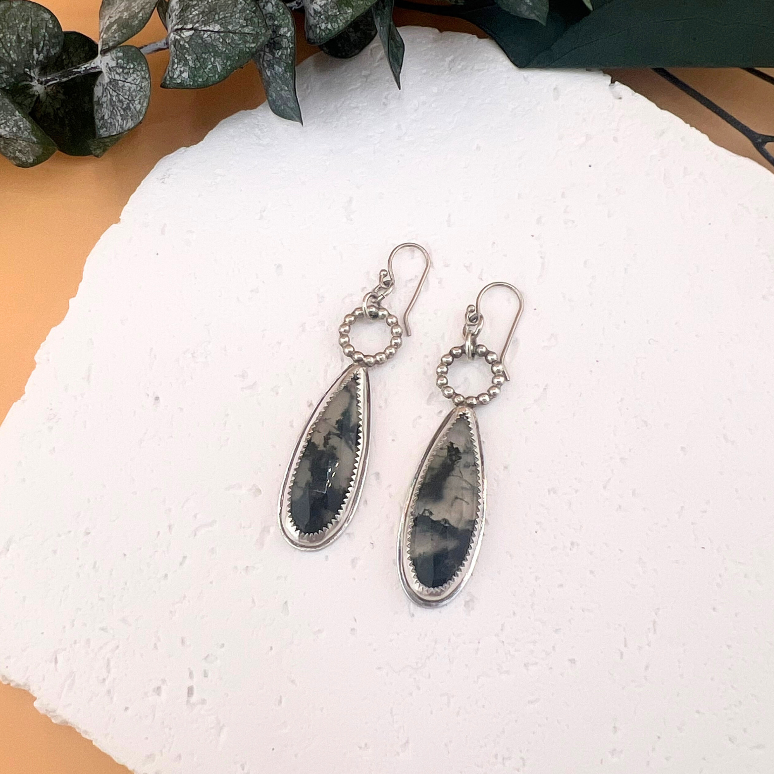One of a kind sterling silver drop earrings with bezel set moss agate stones featuring natural green inclusions.