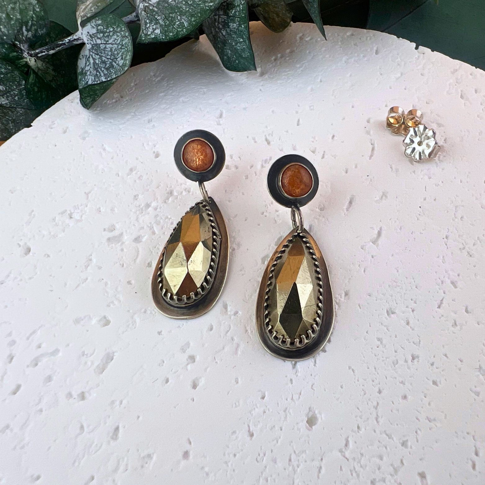 Sterling silver post earrings with round sunstone studs and faceted pyrite drop dangles.
