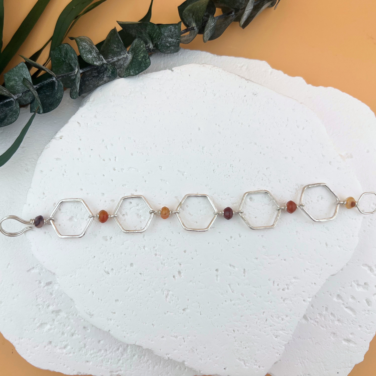 Handcrafted hexagon link bracelet with red banded agate beads in sterling silver.