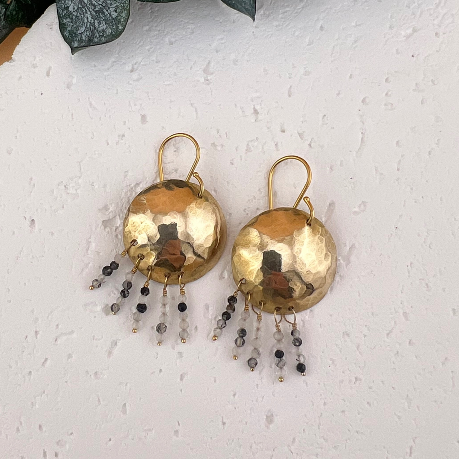Handmade hammered domed brass medallion earrings with charcoal rutilated quartz beaded fringe.