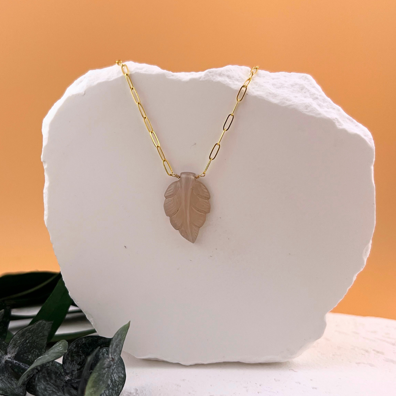 Pink chalcedony leaf necklace with hand carved gemstone on paperclip chain.