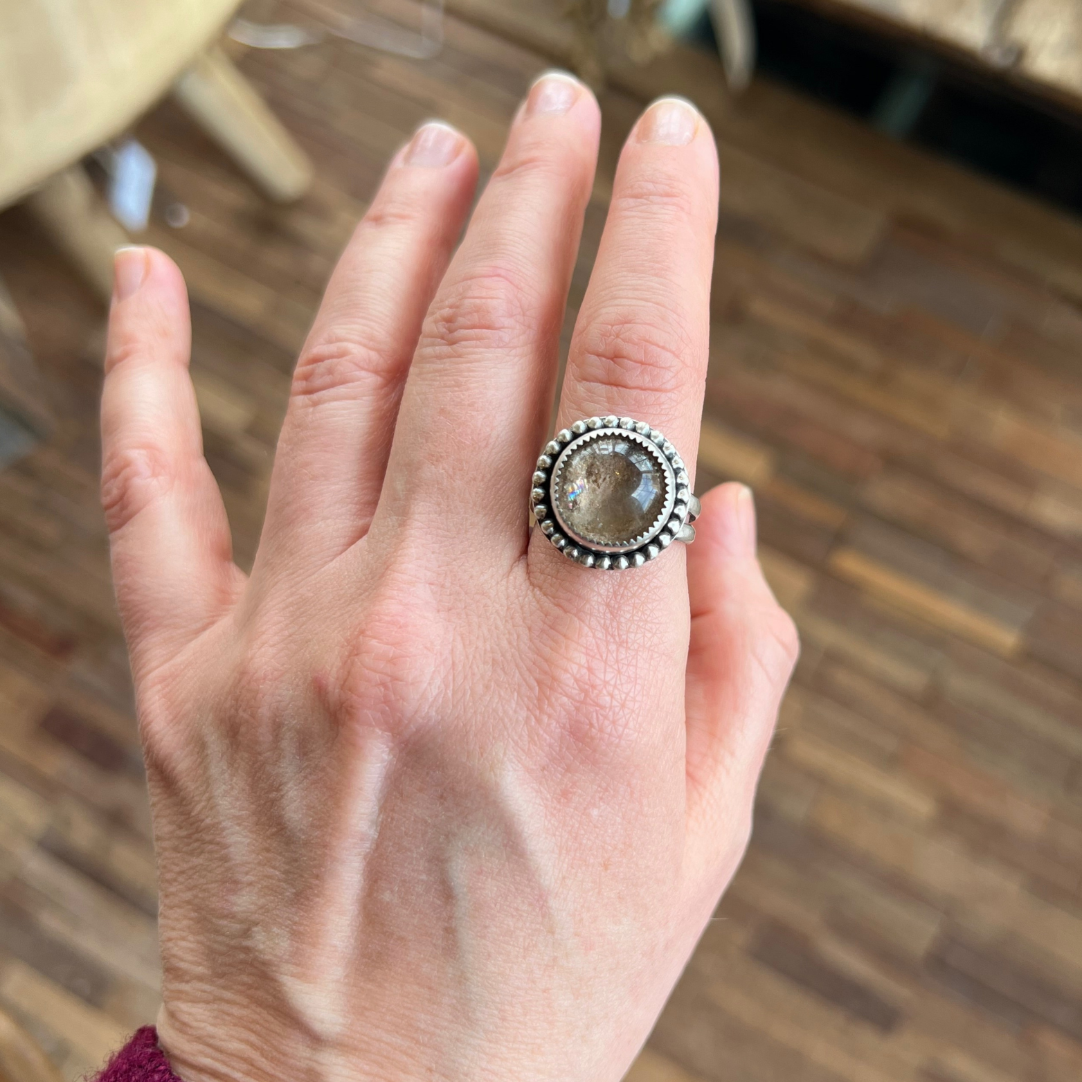 Garden Quartz lodolite ring set in sterling silver worn on hand, showing translucent stone with natural earthy inclusions.