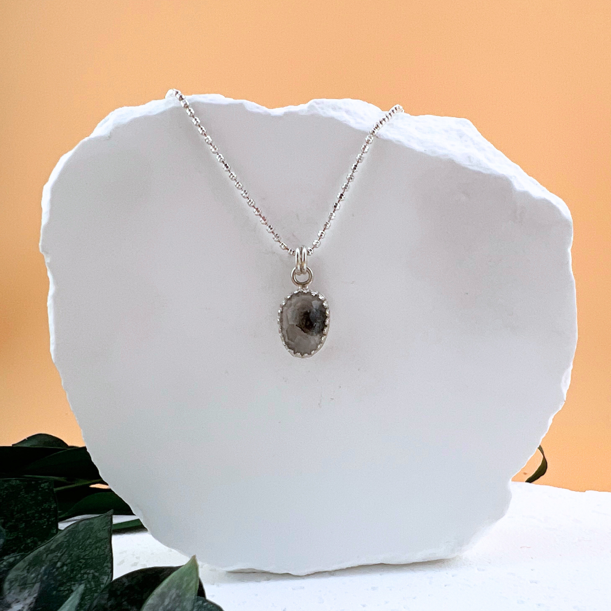 Tiny sterling silver necklace featuring a natural Herkimer diamond gemstone pendant on a delicate silver chain.
