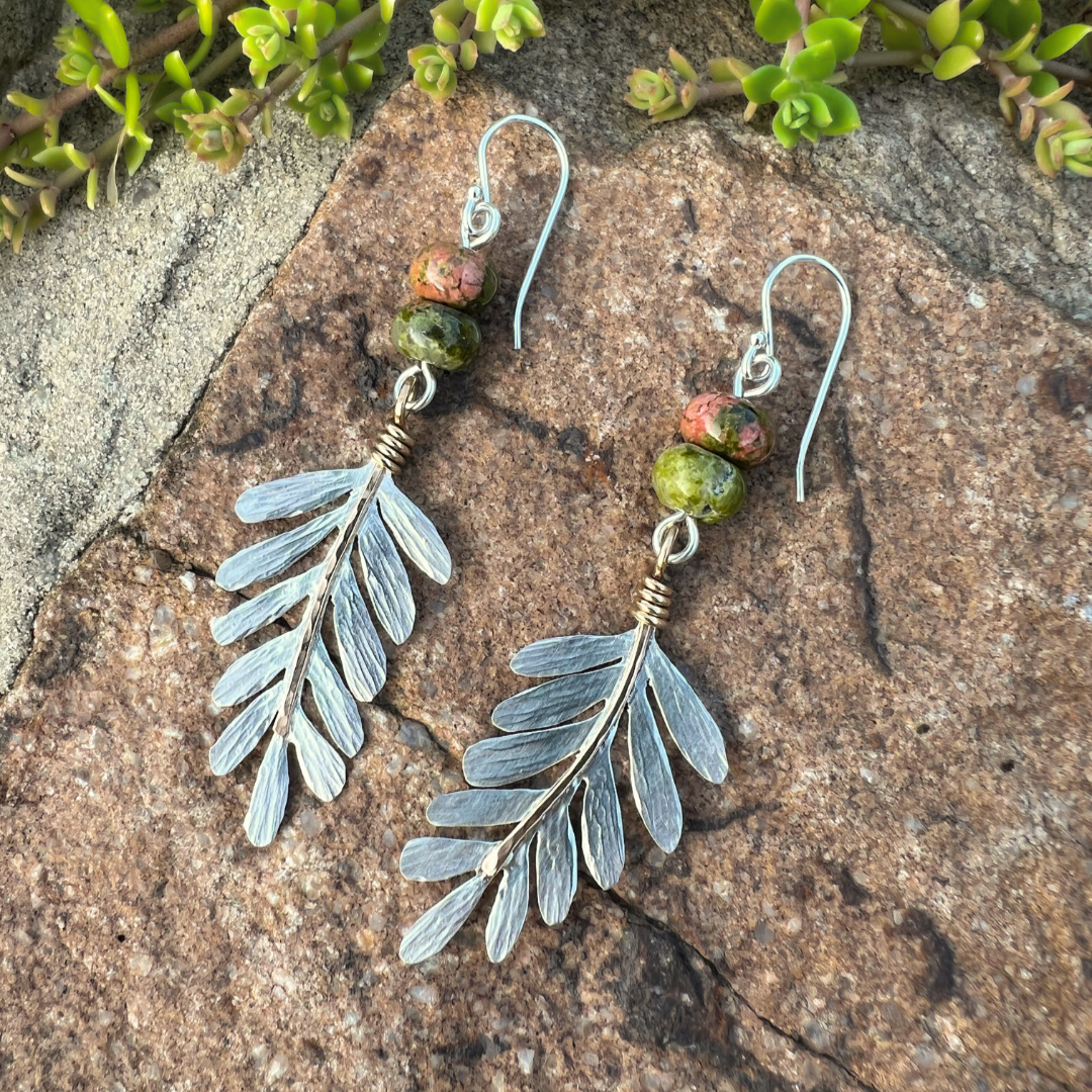 A pair of sterling silver and 14kt gold fill dangle earrings, Gilded Frond Earrings. Featuring hand sawn fern leaves with gold accents and green and salmon colored unakite roundel beads.
