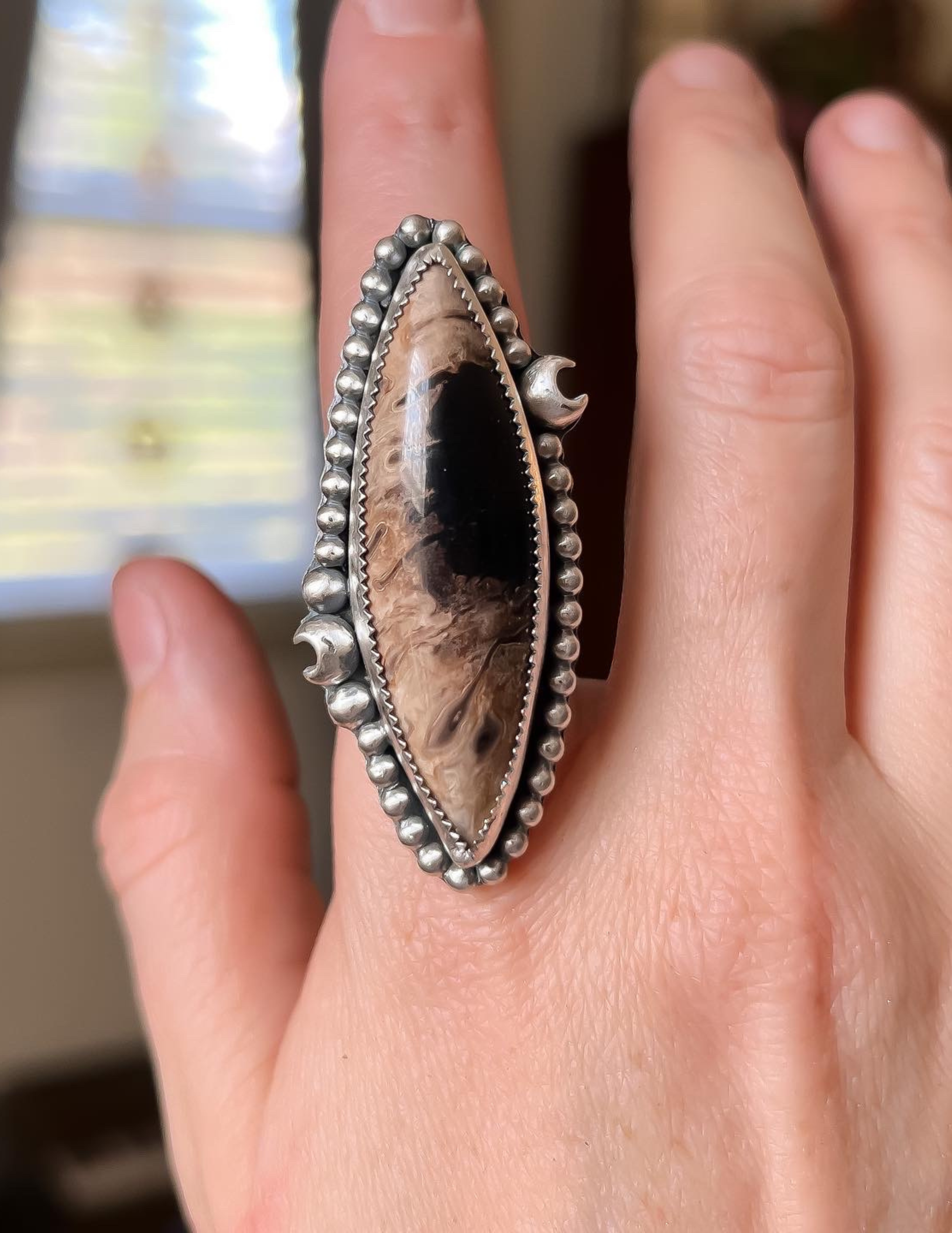 One of a kind petrified palm root statement ring with crescent moon accents.