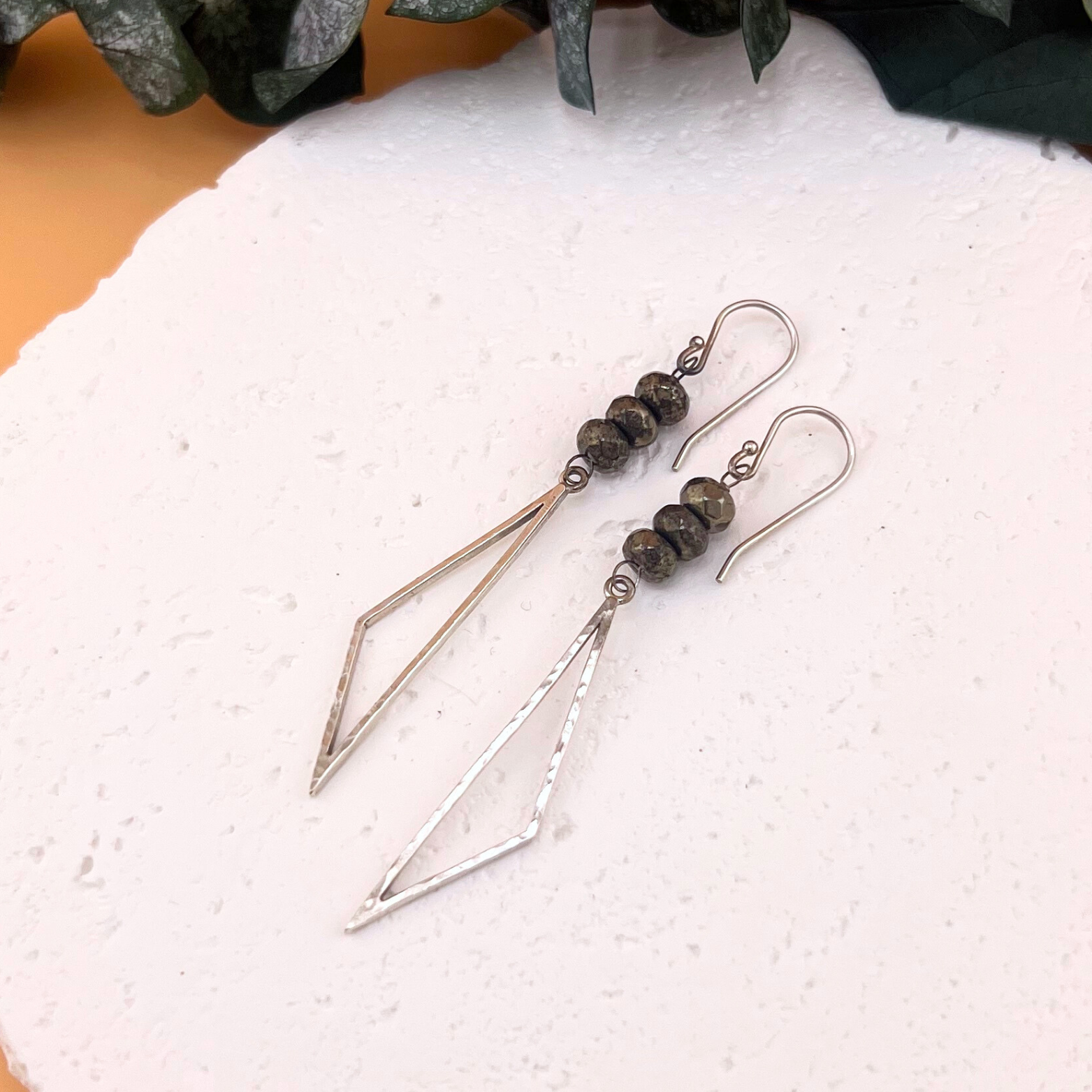 Handmade sterling silver earrings with hammered triangle drops and faceted pyrite bead accents.