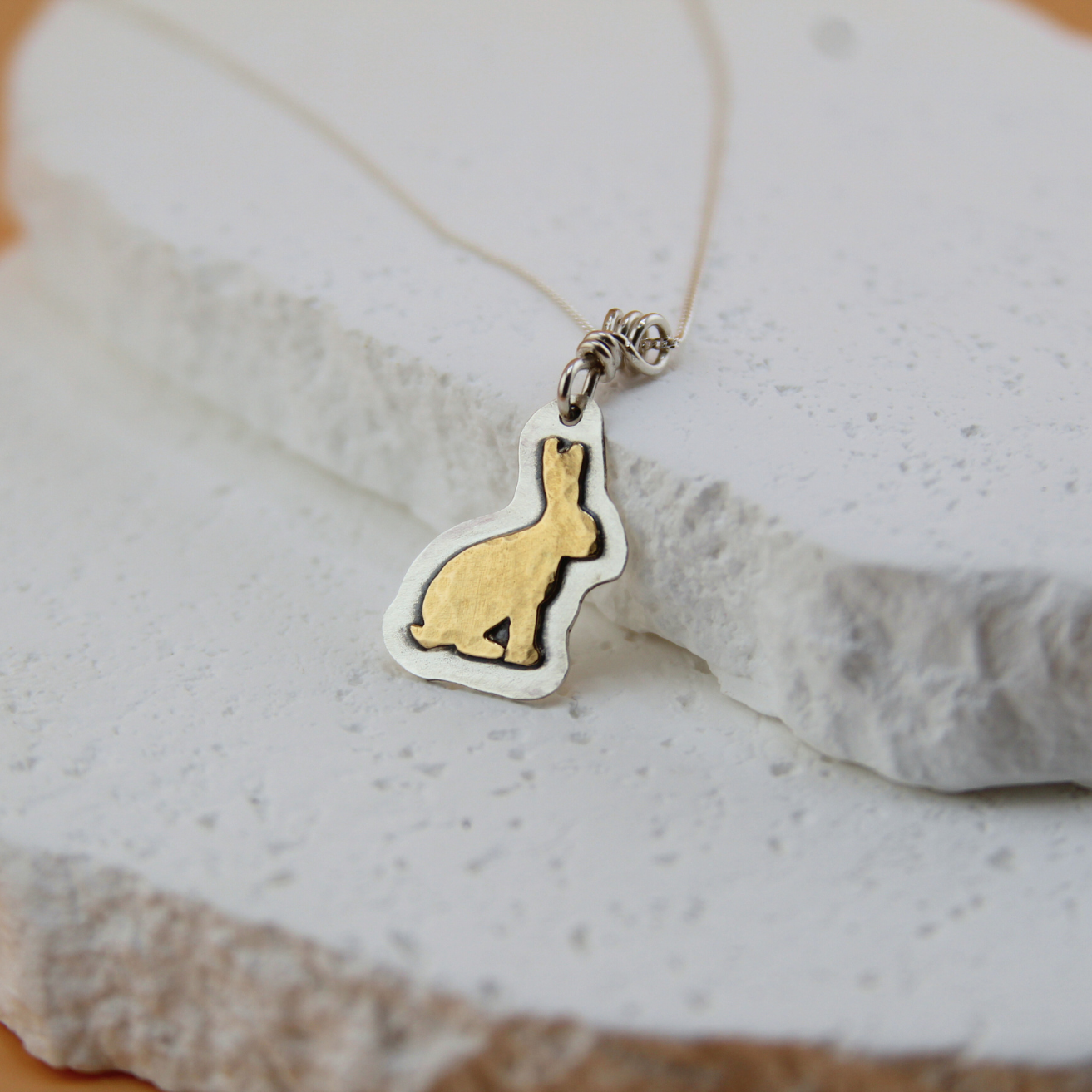 Heritage Rabbit necklace in brass and sterling silver.