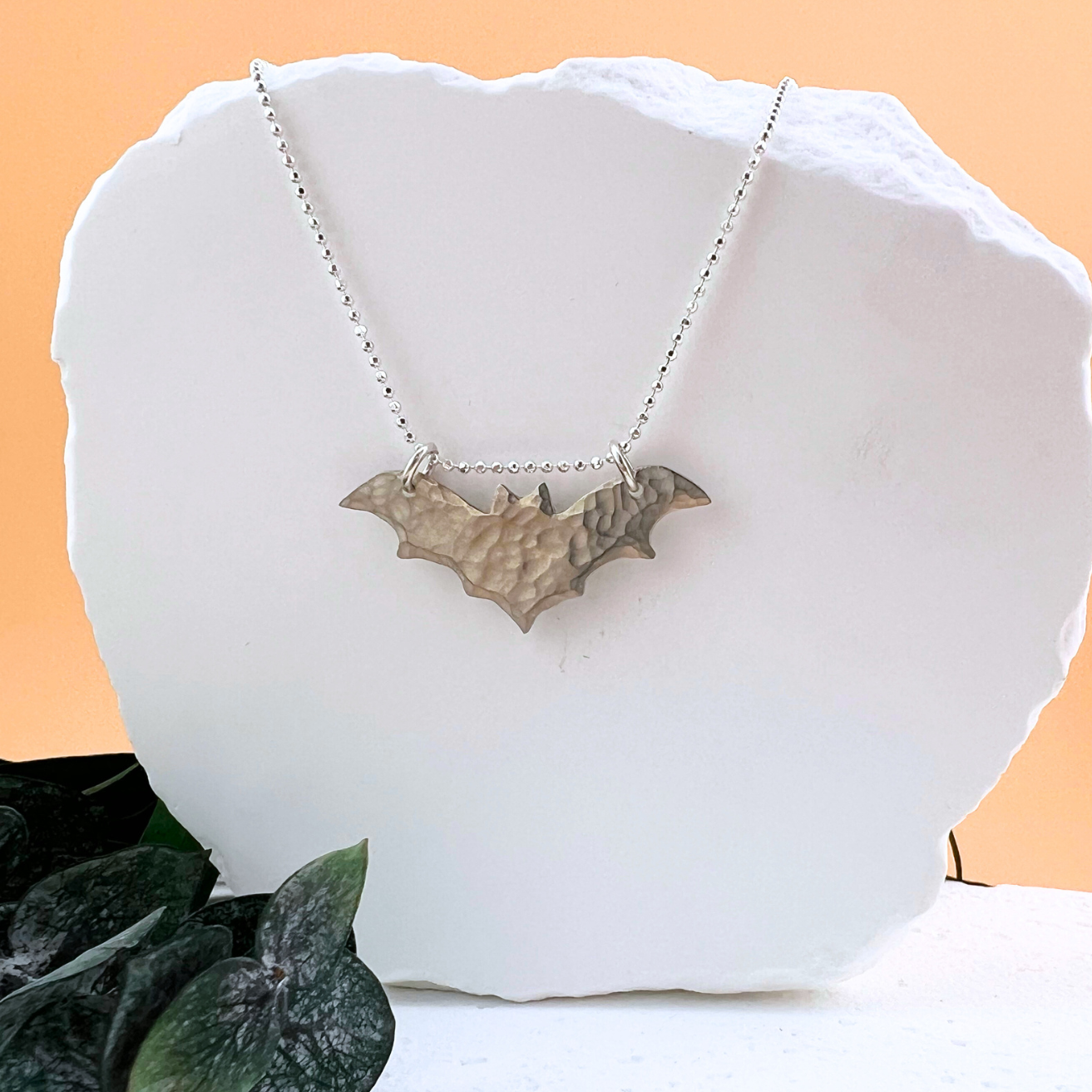 Handcrafted sterling silver nocturne style bat necklace with hammered texture.