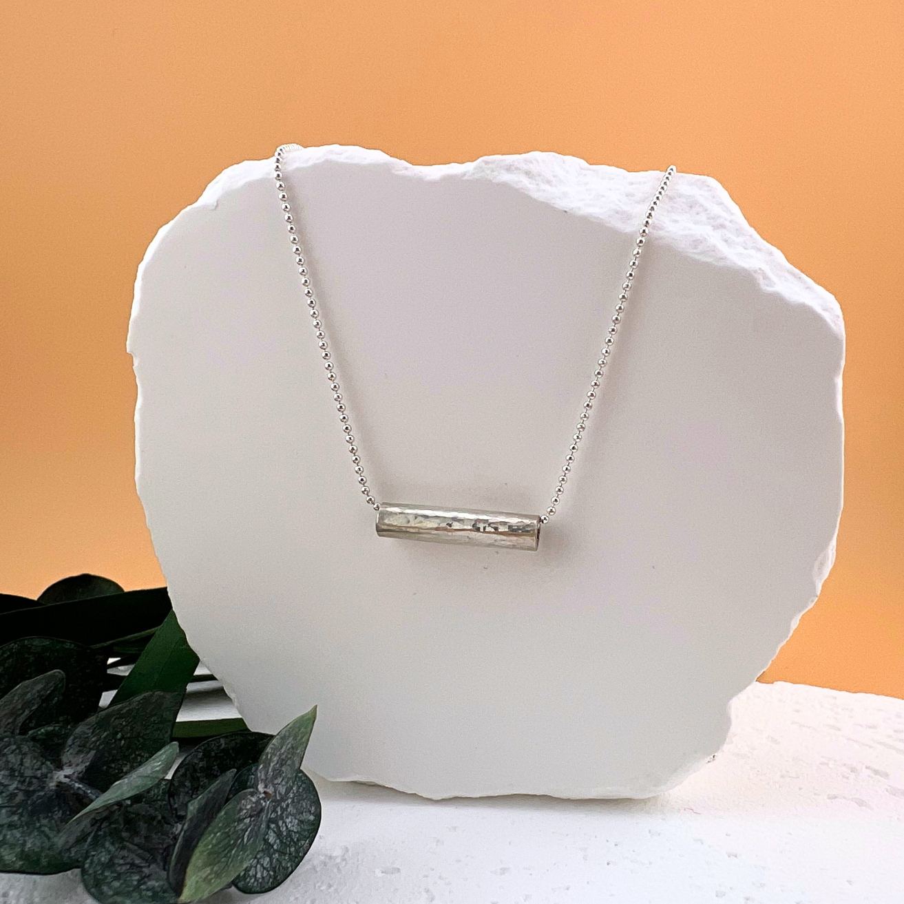Sterling silver hammered bar necklace on a delicate beaded chain.
