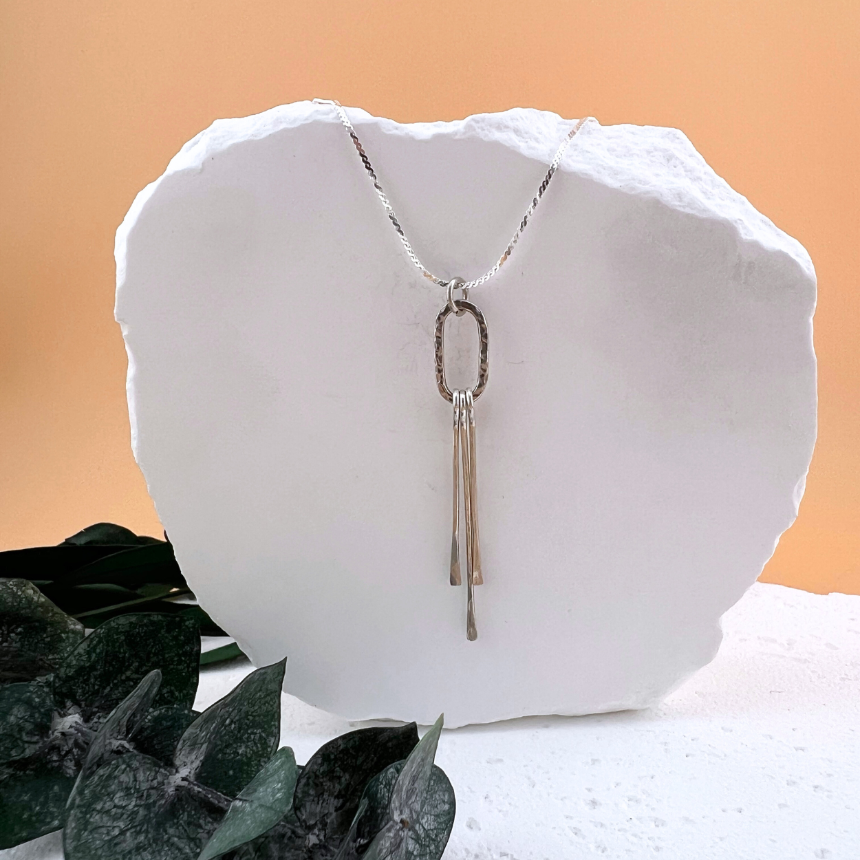 Sterling silver Fringe Elements Necklace featuring a hand-hammered oval anchor link with delicate hammered fringe on an 18-inch chain.