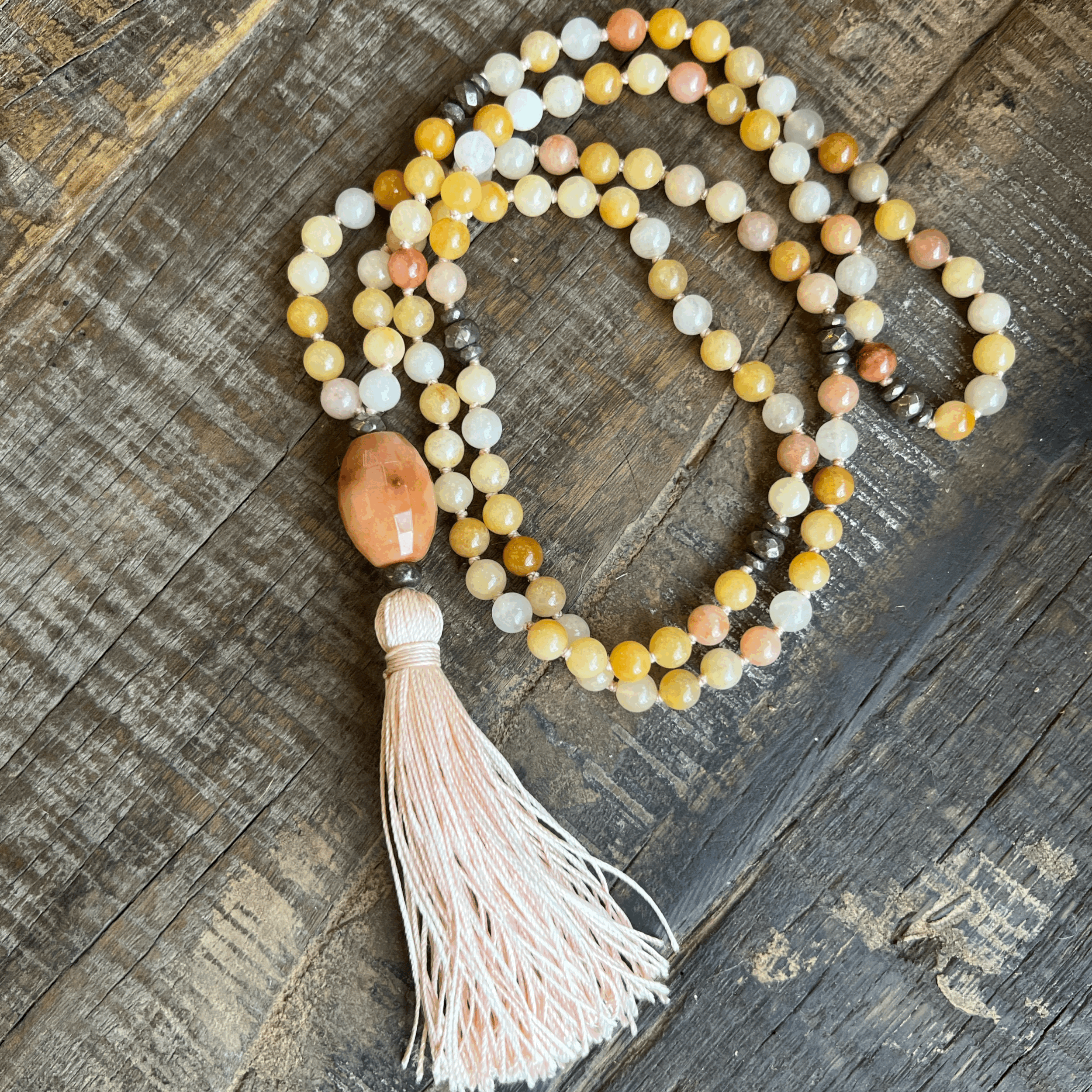 Custom gobi jade mala with pyrite accents and a peach tassel.
