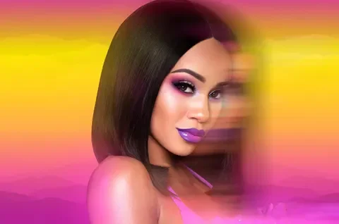 A woman with straight dark hair, purple lipstick, and eye makeup, against a vibrant pink and yellow gradient background.