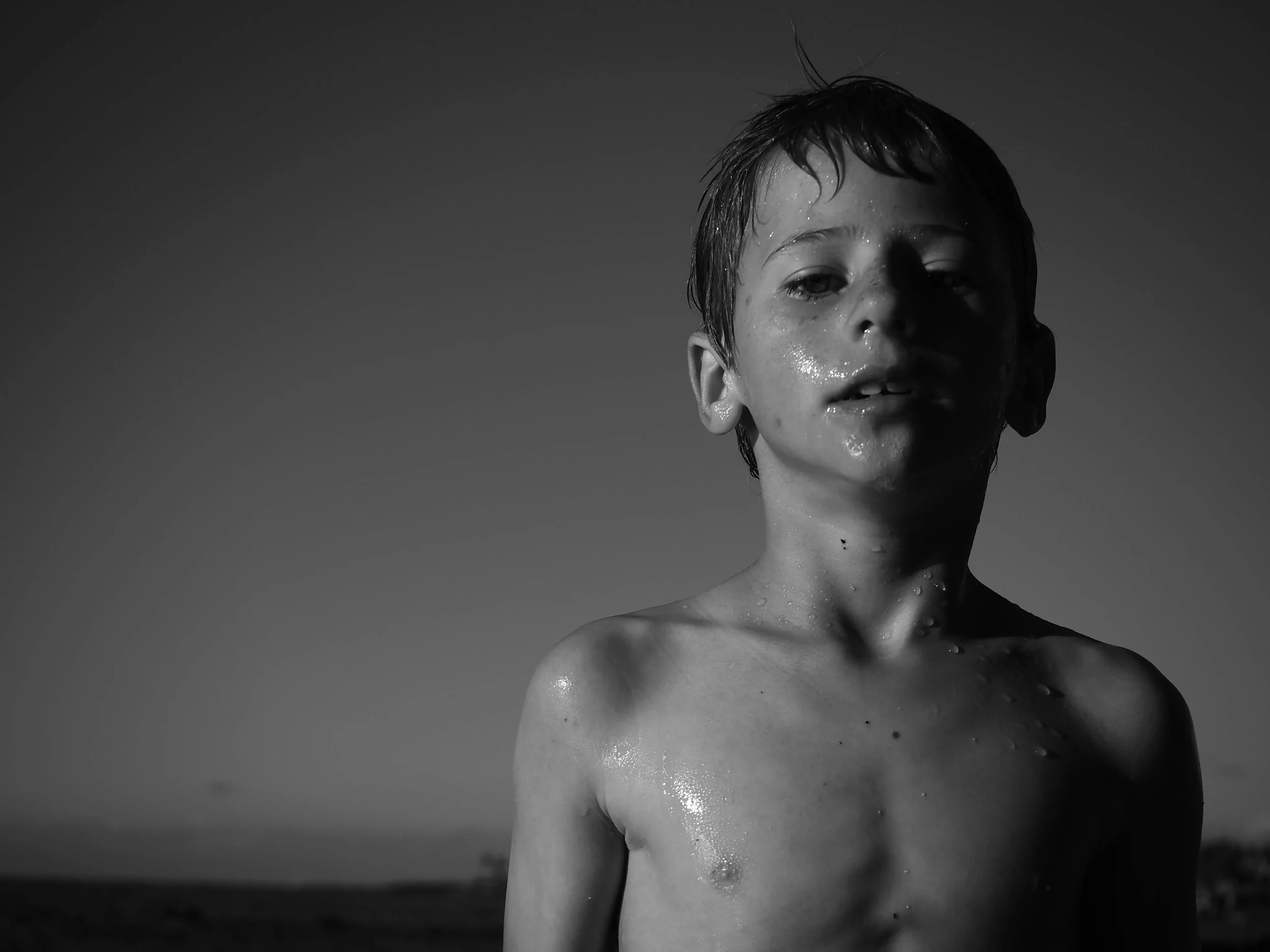 boy on beach in Hawaii black and white