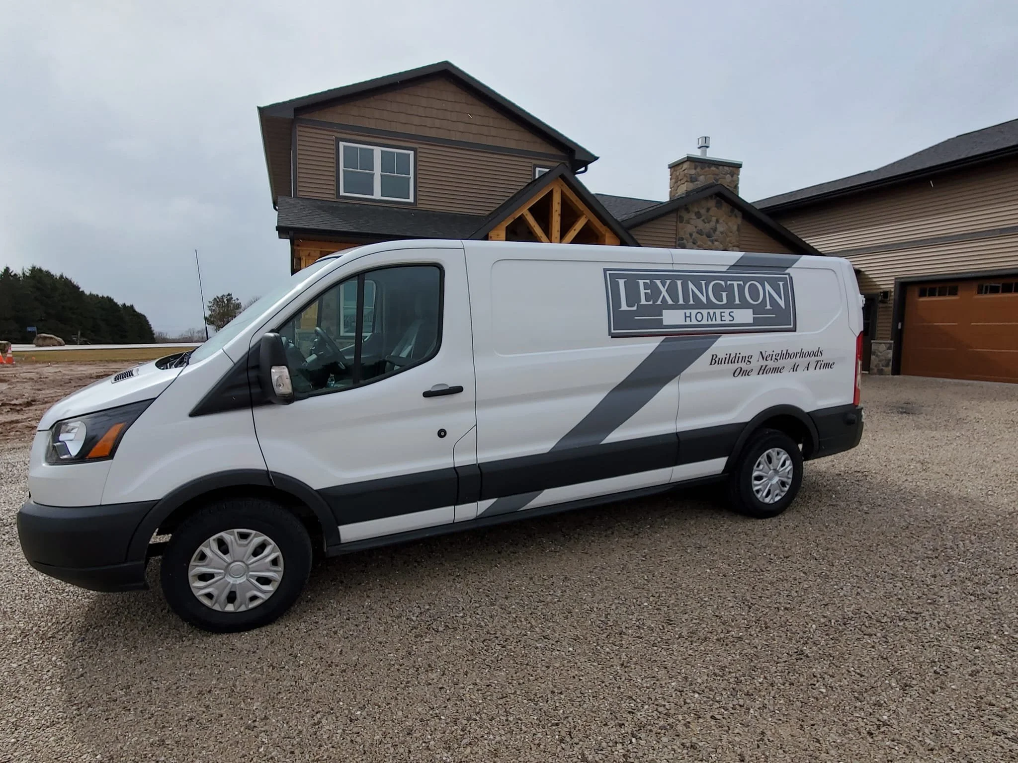 A white Lincoln Homes van parked in front of a newly constructed house with a two-story front and a garage on the right.