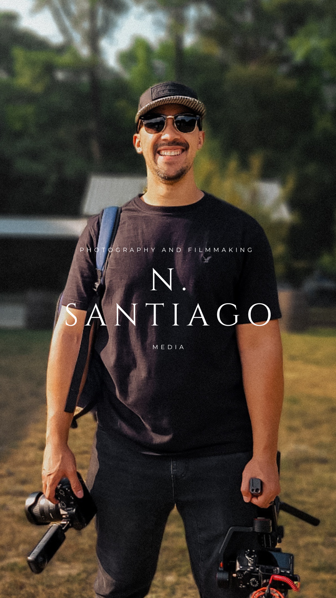 Man wearing sunglasses and a cap, holding a camera and a gimbal, smiling outdoors with trees in the background, promotional text overlay for a photography and filmmaking media company.