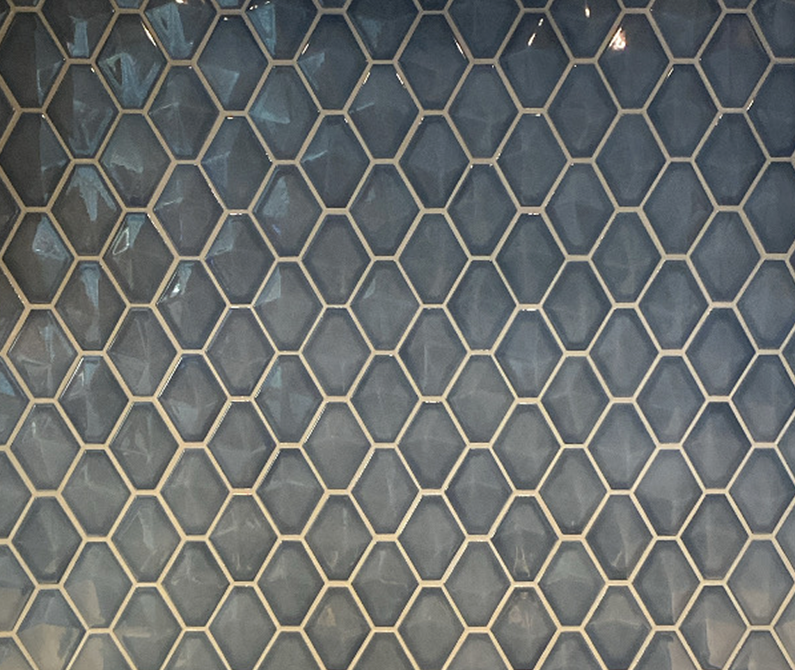 Close-up of a honeycomb-shaped wire mesh grid covering a wall or window.
