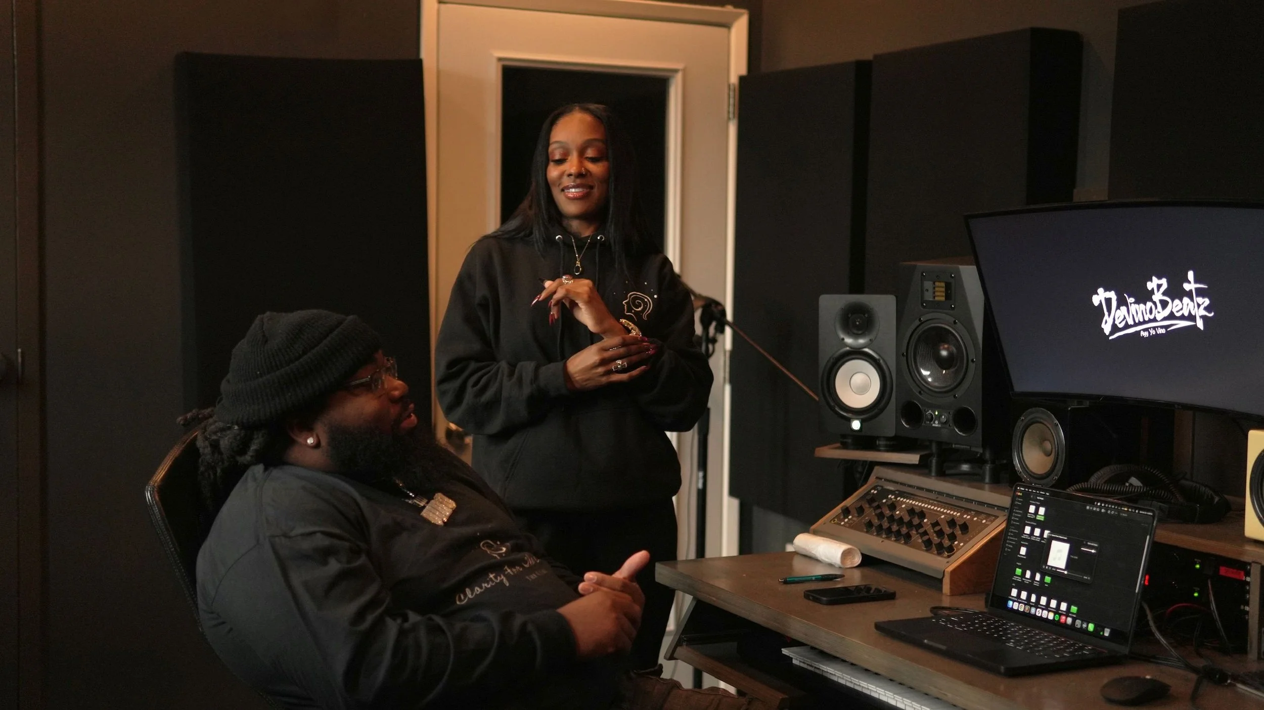 Two creative professionals in a music studio