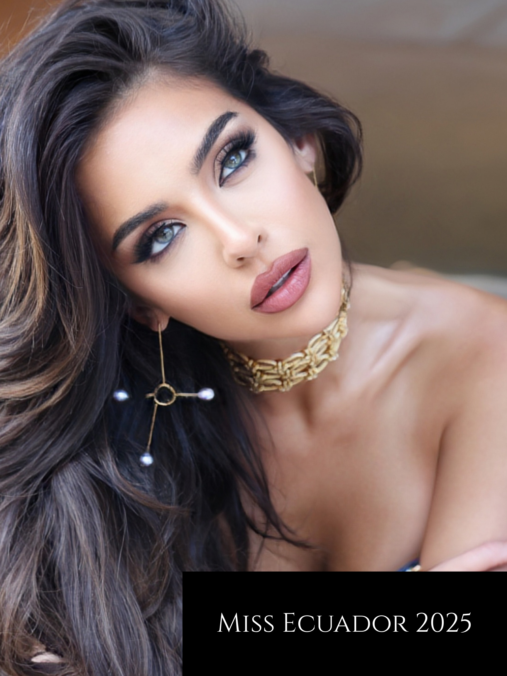A close-up portrait of a woman with long, dark, wavy hair and striking makeup, wearing a gold necklace and a distinctive earring, with a caption that reads 'Miss Ecuador 2025'.