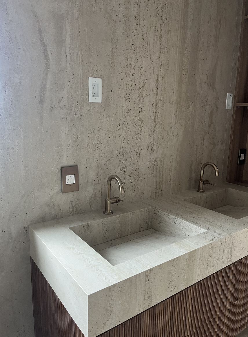 Clean and minimal travertine wall and sink installation in Charlotte bathroom