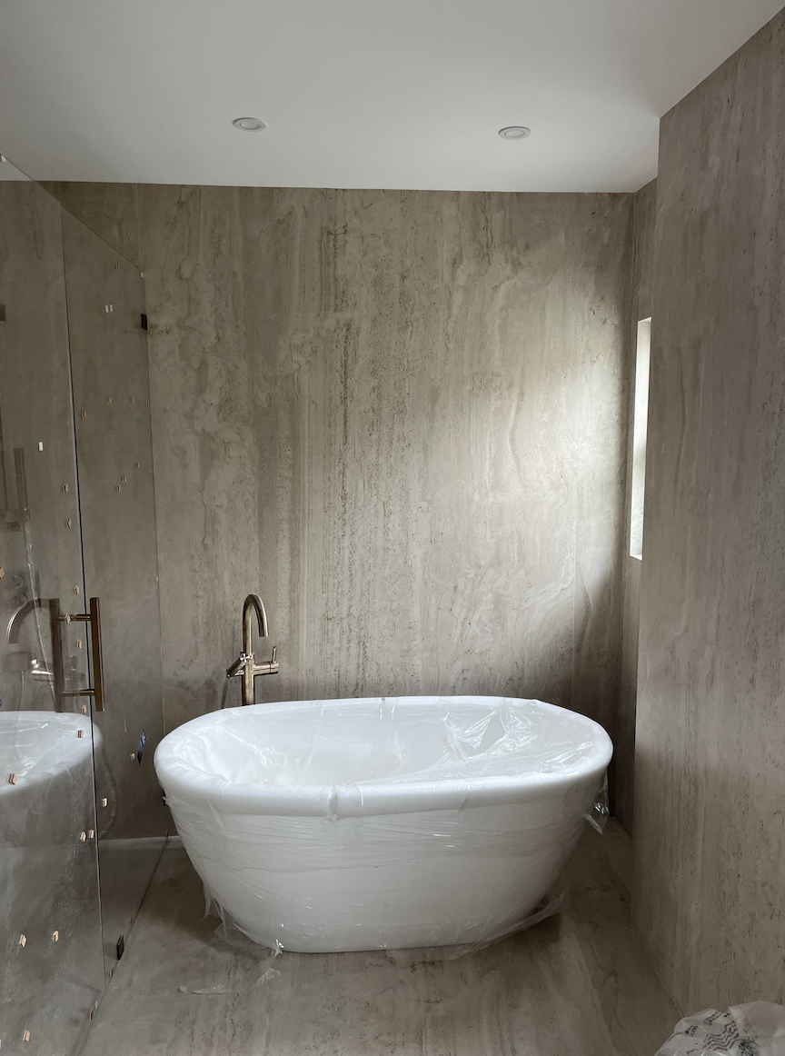 Freestanding bathtub installation in modern bathroom in Charlotte, NC