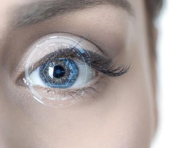 A human eye is overlaid with a glowing, geometric interface, suggesting advanced visual‑technology interaction.