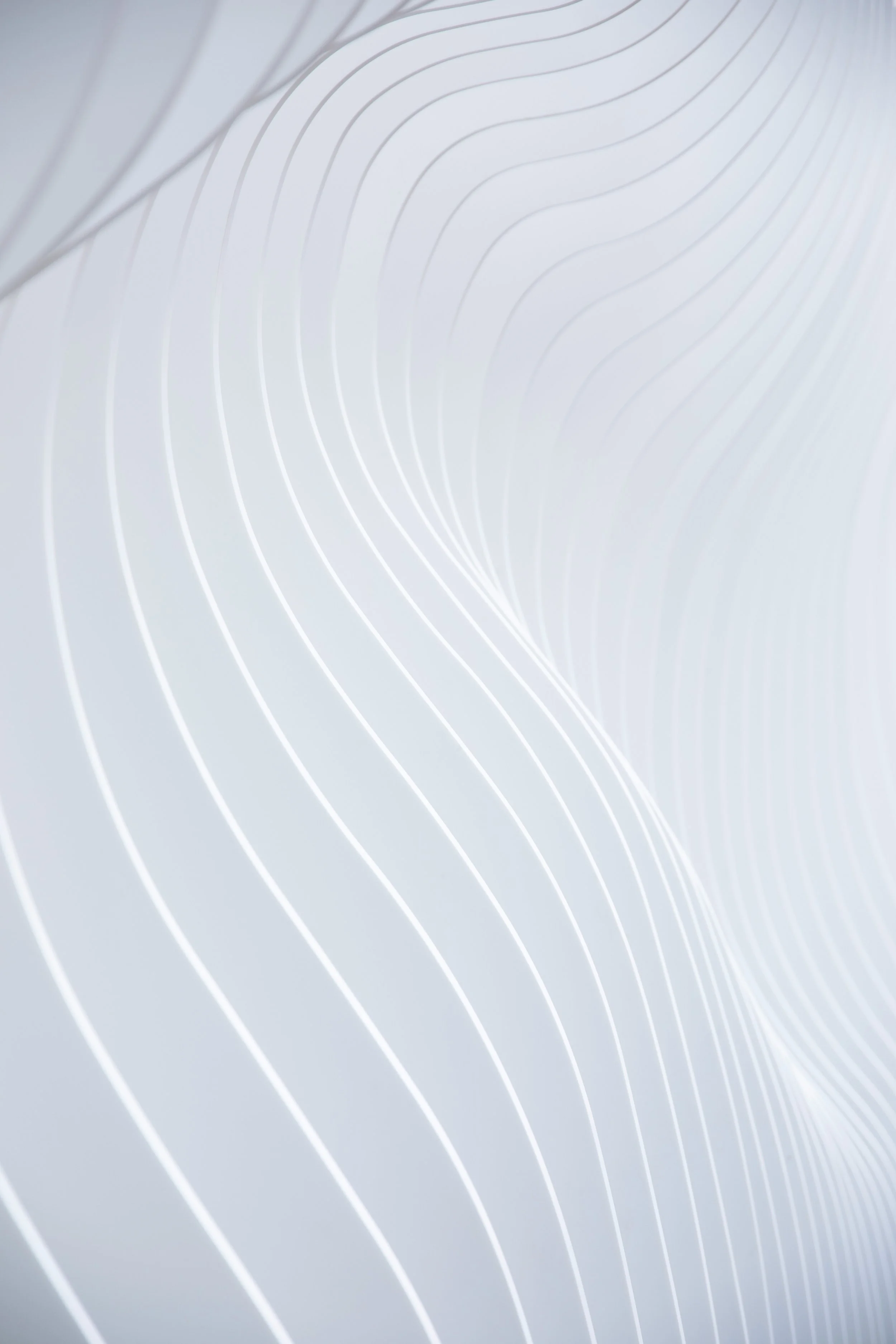 Abstract white surface with curved lines creating a modern, sleek design.