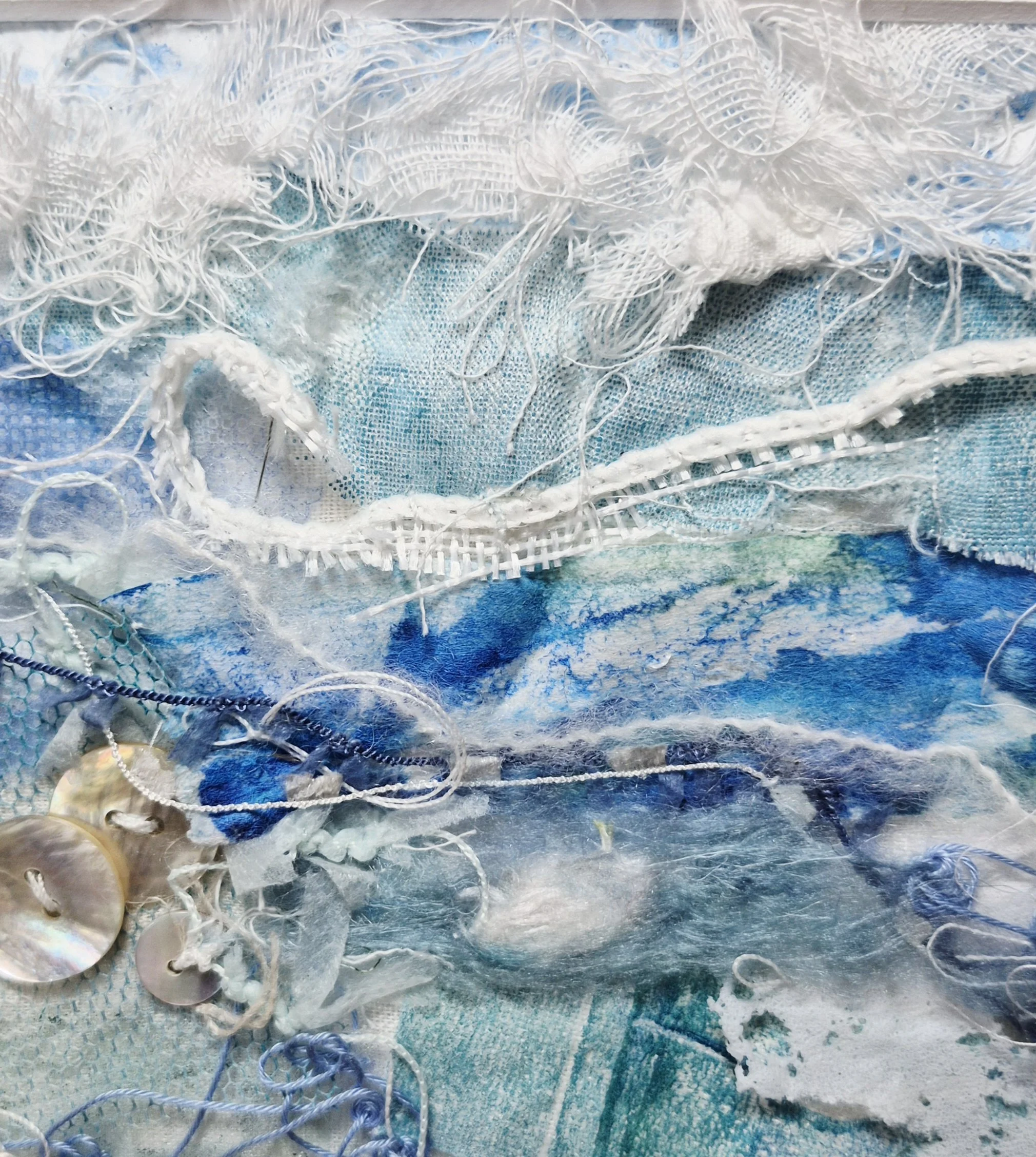 Close-up image of a fabric with multiple layers of white mesh, threads, and thin wires or strings intertwined, with some blue background visible through the mesh.
