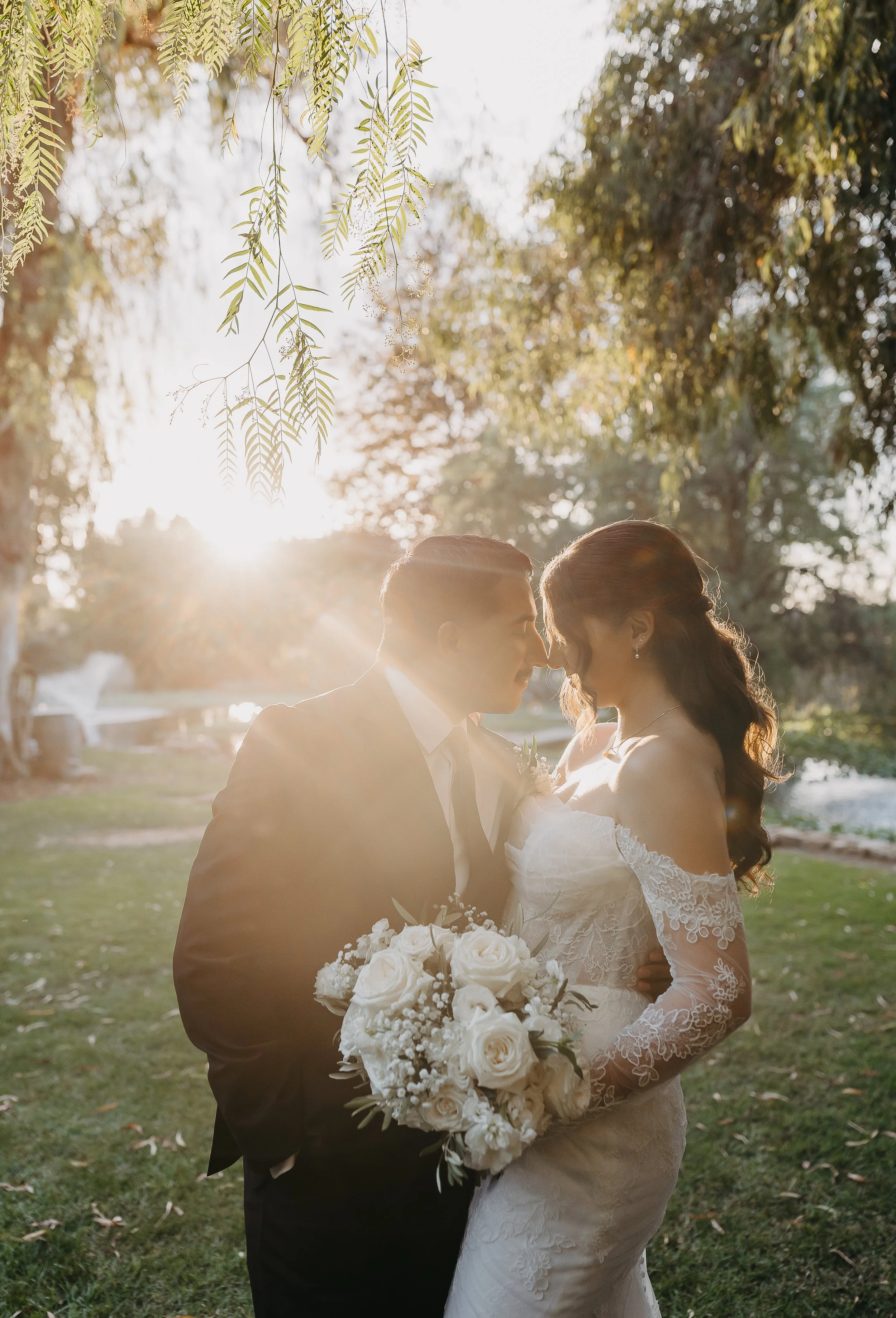 Bride and groom in their formal wedding attire during their intimate portraits at golden hour.