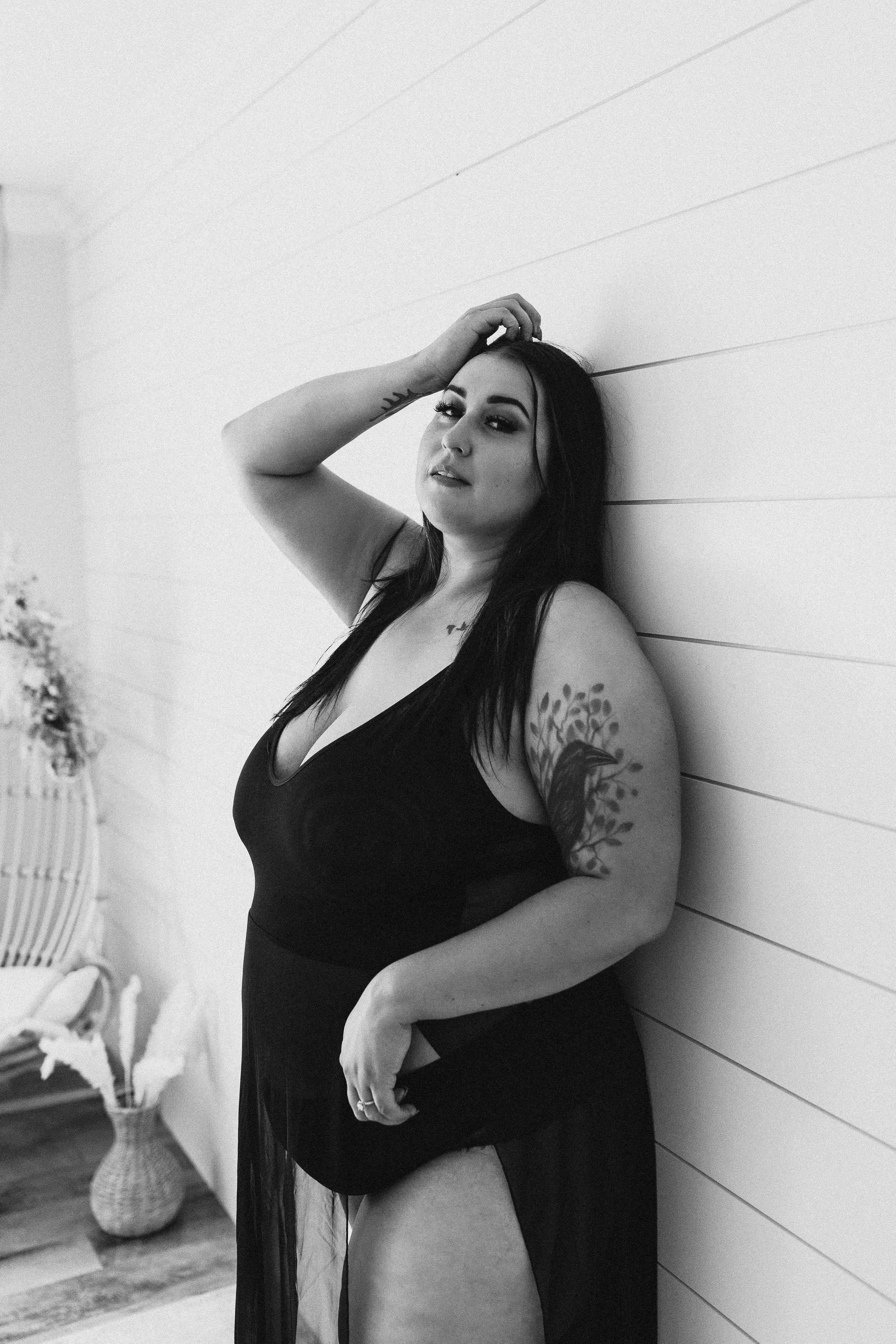 bride in all black lingerie leaned against boudoir studio wall