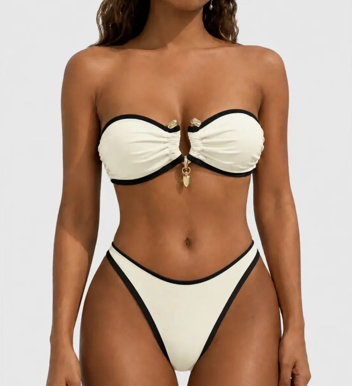 Luxury white with black trim swim suit with gold detail middle of bust