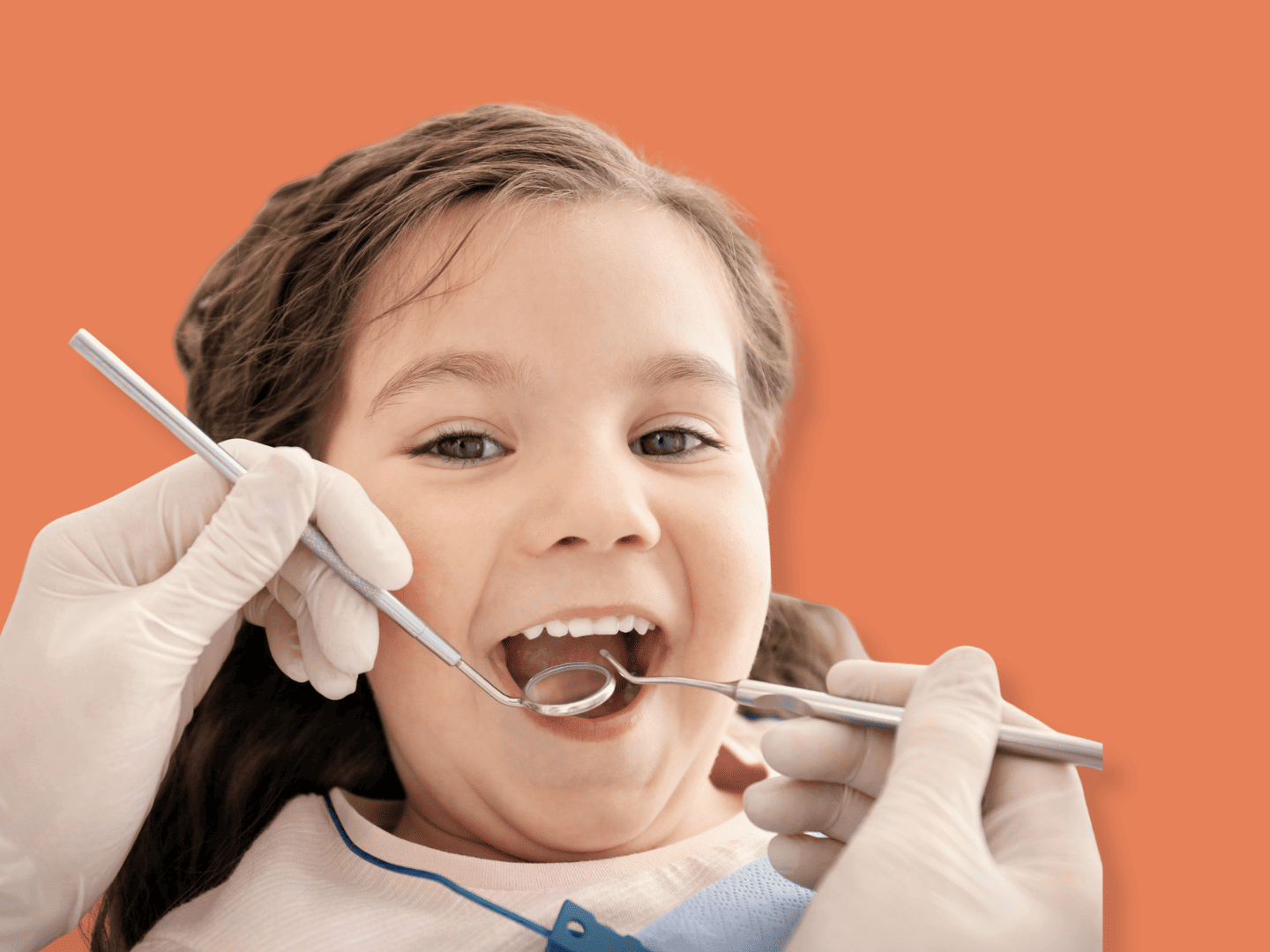 Young girl at a dental checkup with a dentist using dental tools in her mouth against an orange background.