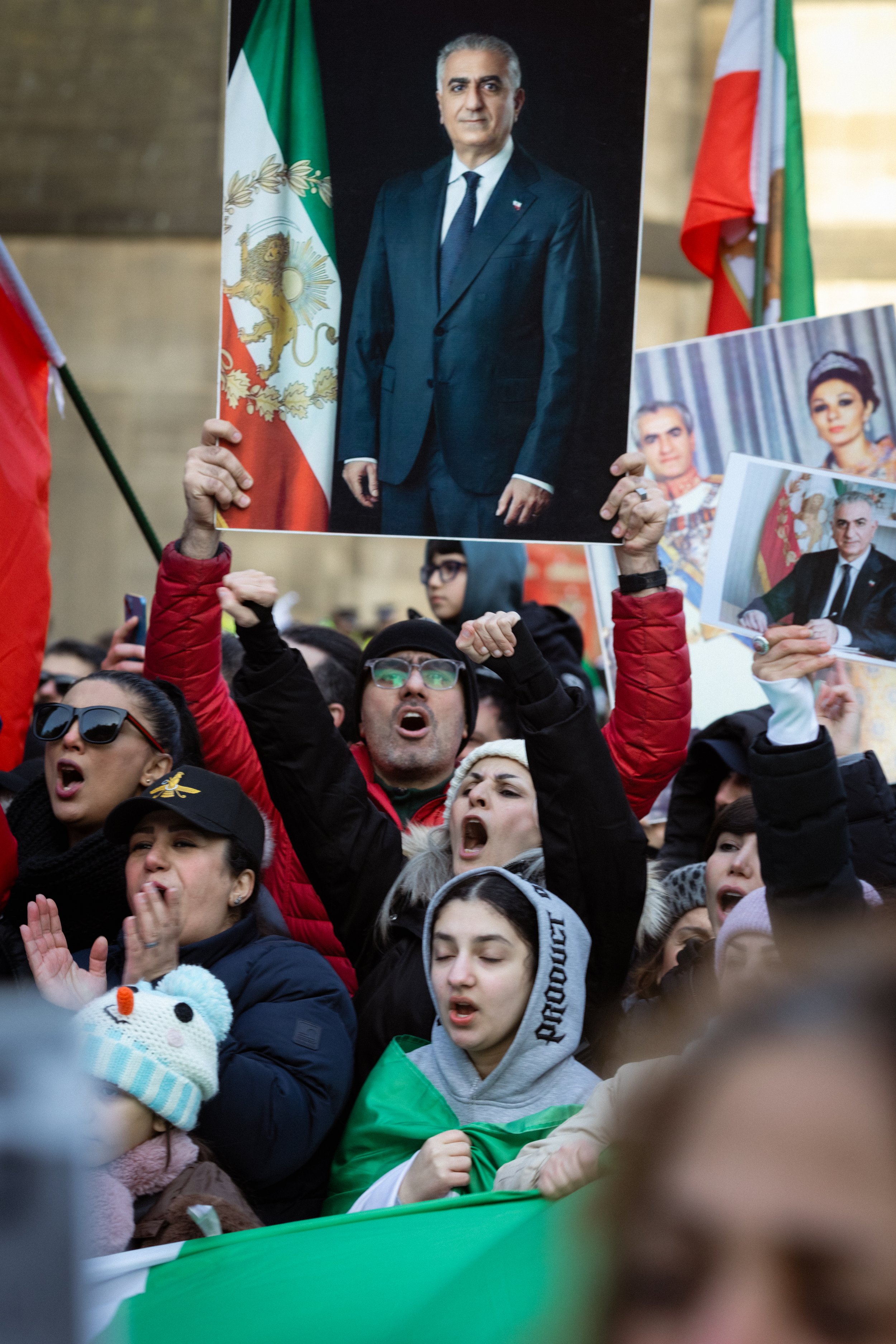 Iranian supporters holding pictures and placards of 
Mohammad Reza Pahlavi gathered in St Peter's Square. 