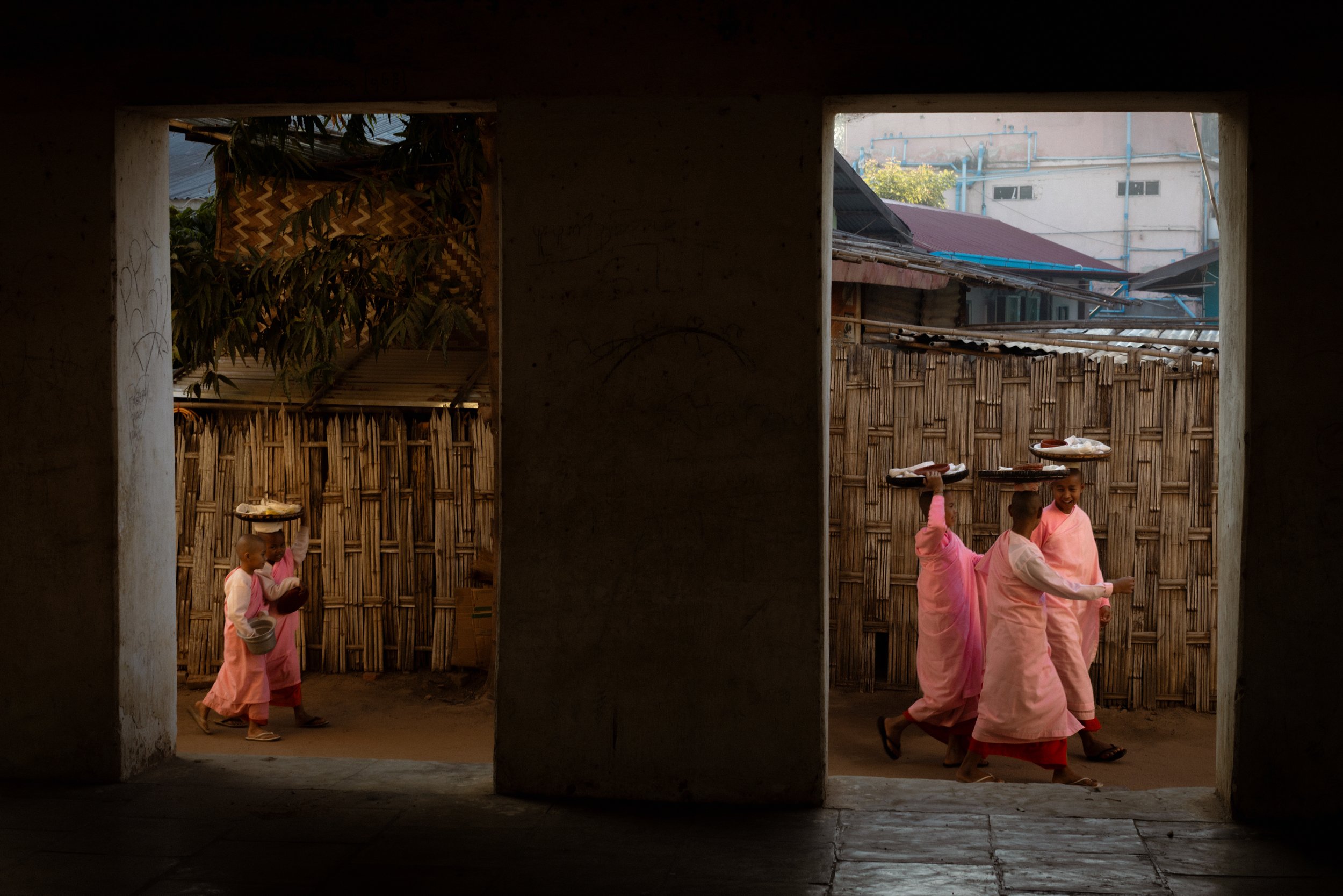 Novice Buddhist Monks collect rice early in the morning. Many of the monks are orphans; they spend most of their lives in the monastery, where they are supported with food and education. Bagan, Myanmar, 2020