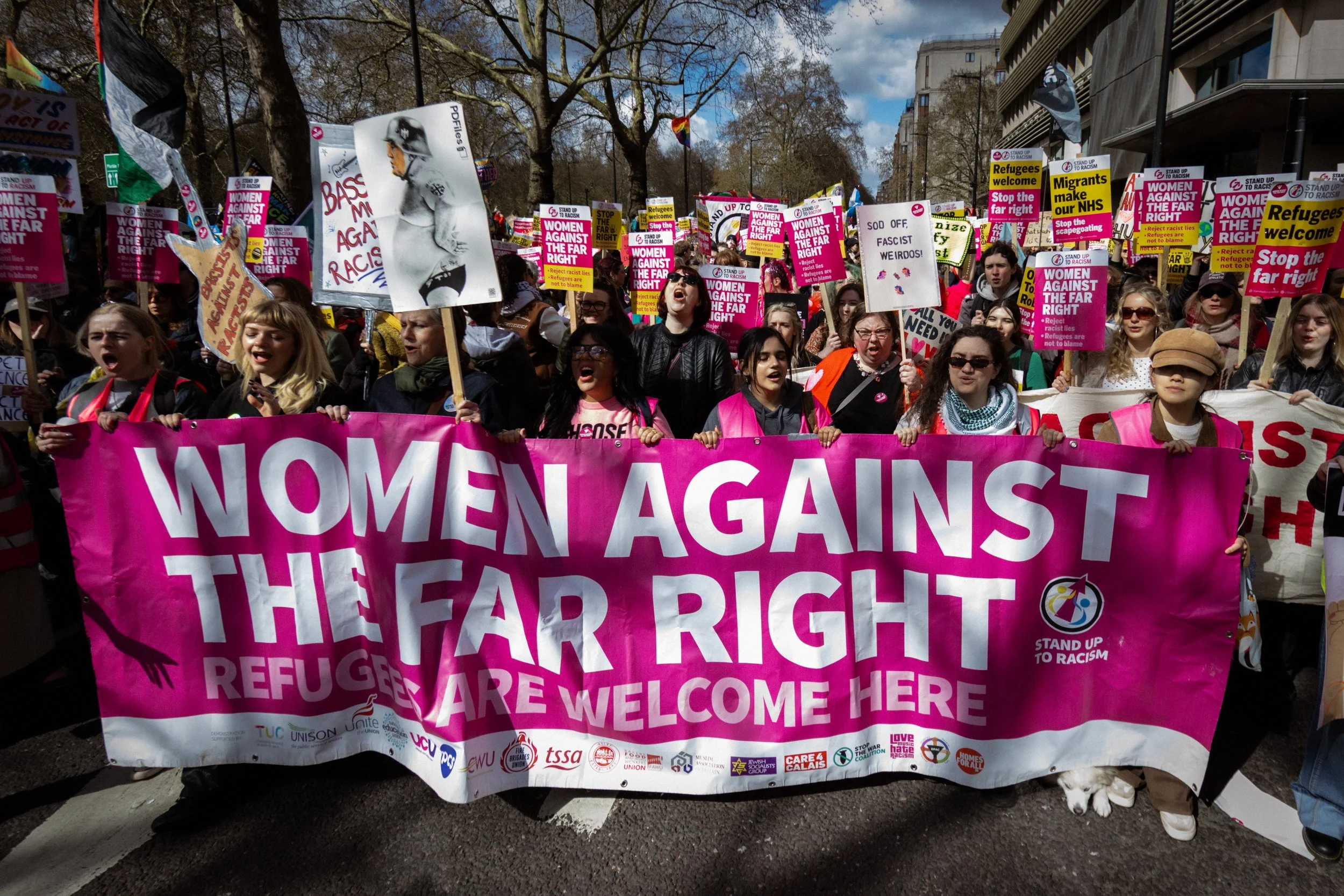 Women Against The Far Right hold a large banner before the march.