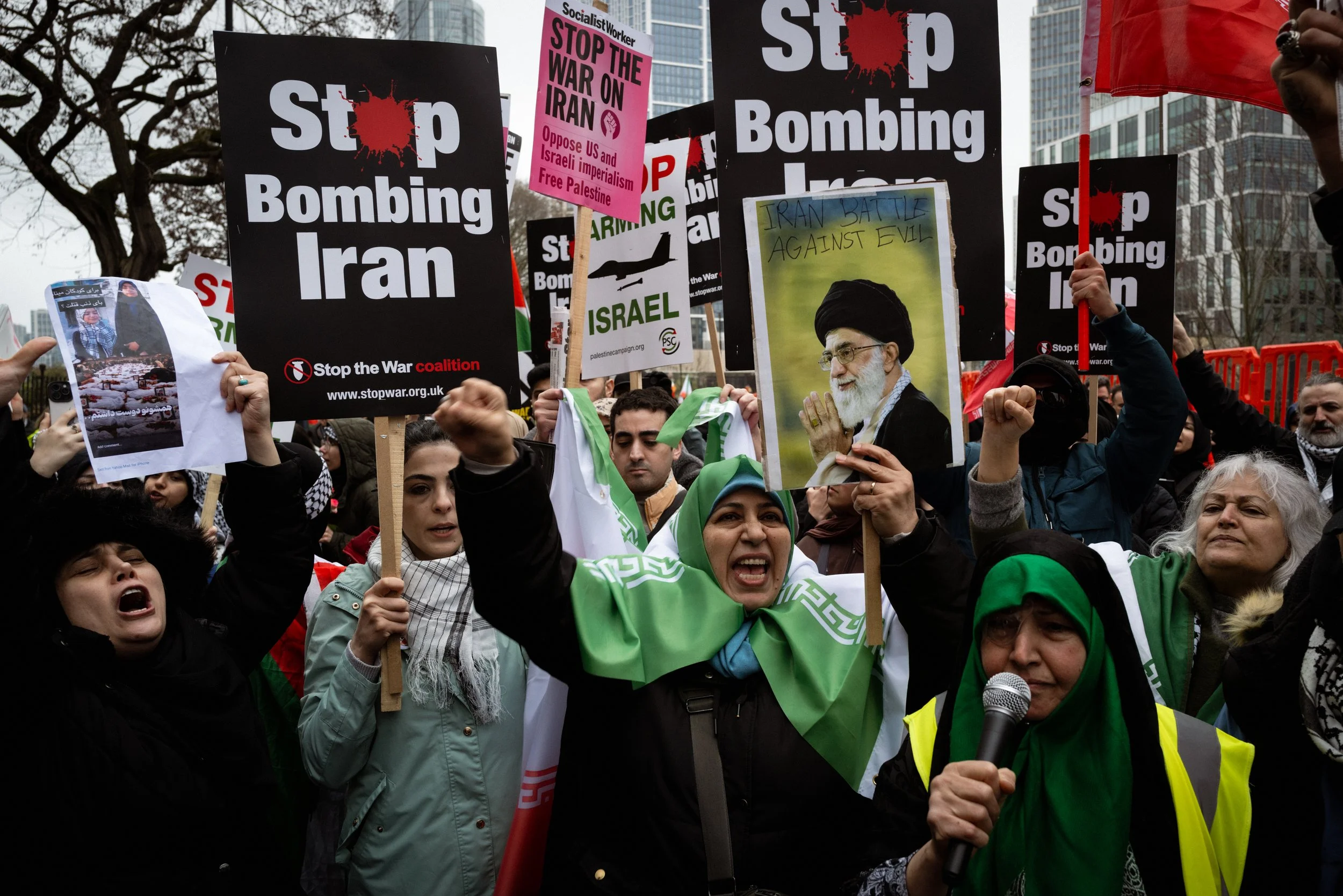 People gather outside the American Embassy and chant in protest against the bombing of Iran. 