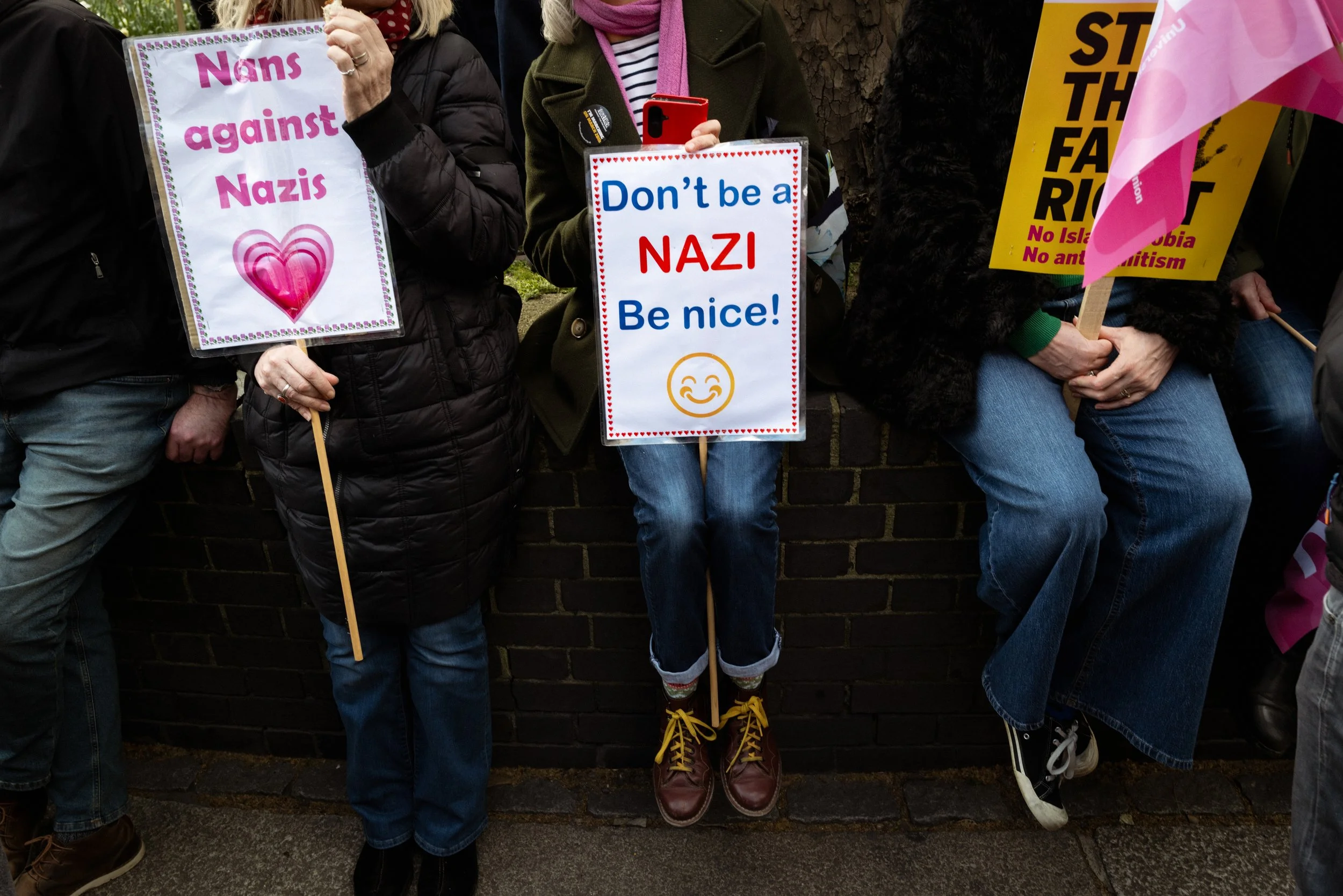 Protesters hold placards before the march starts.