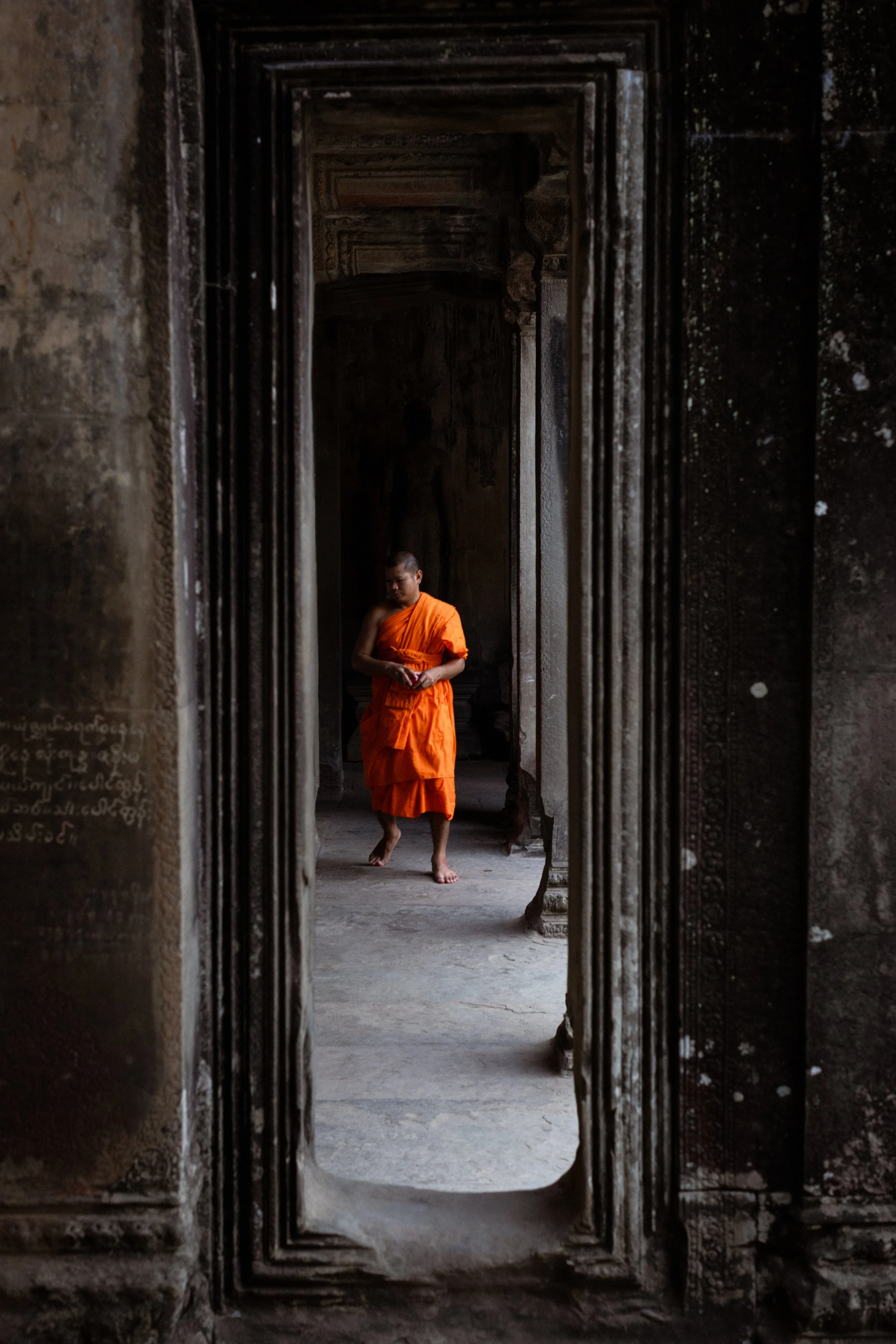 A Buddist Monk walks through Angkor Wat. Siem Reap, Cambodia, 2020