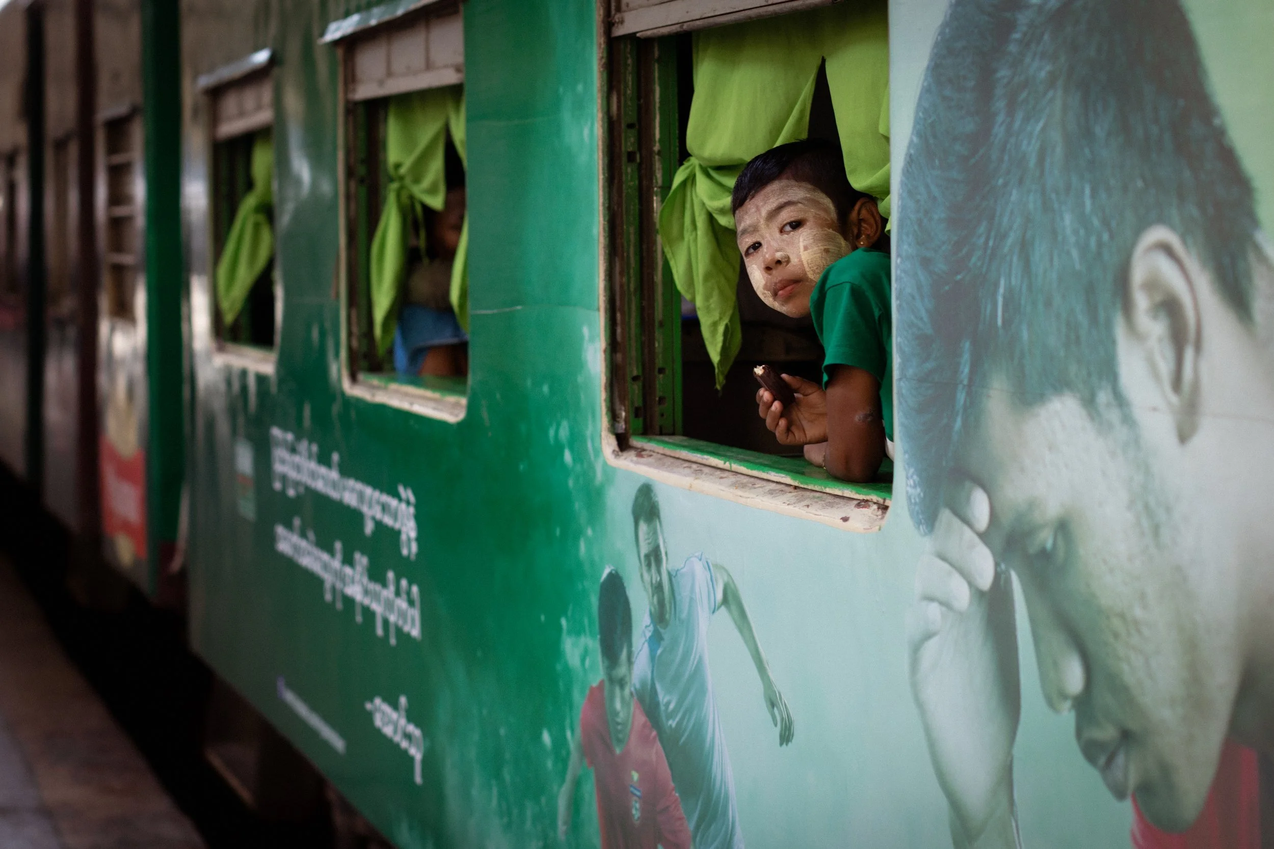 A boy looks out the window of the train before it departs. Yangon, Myanmar, 2020