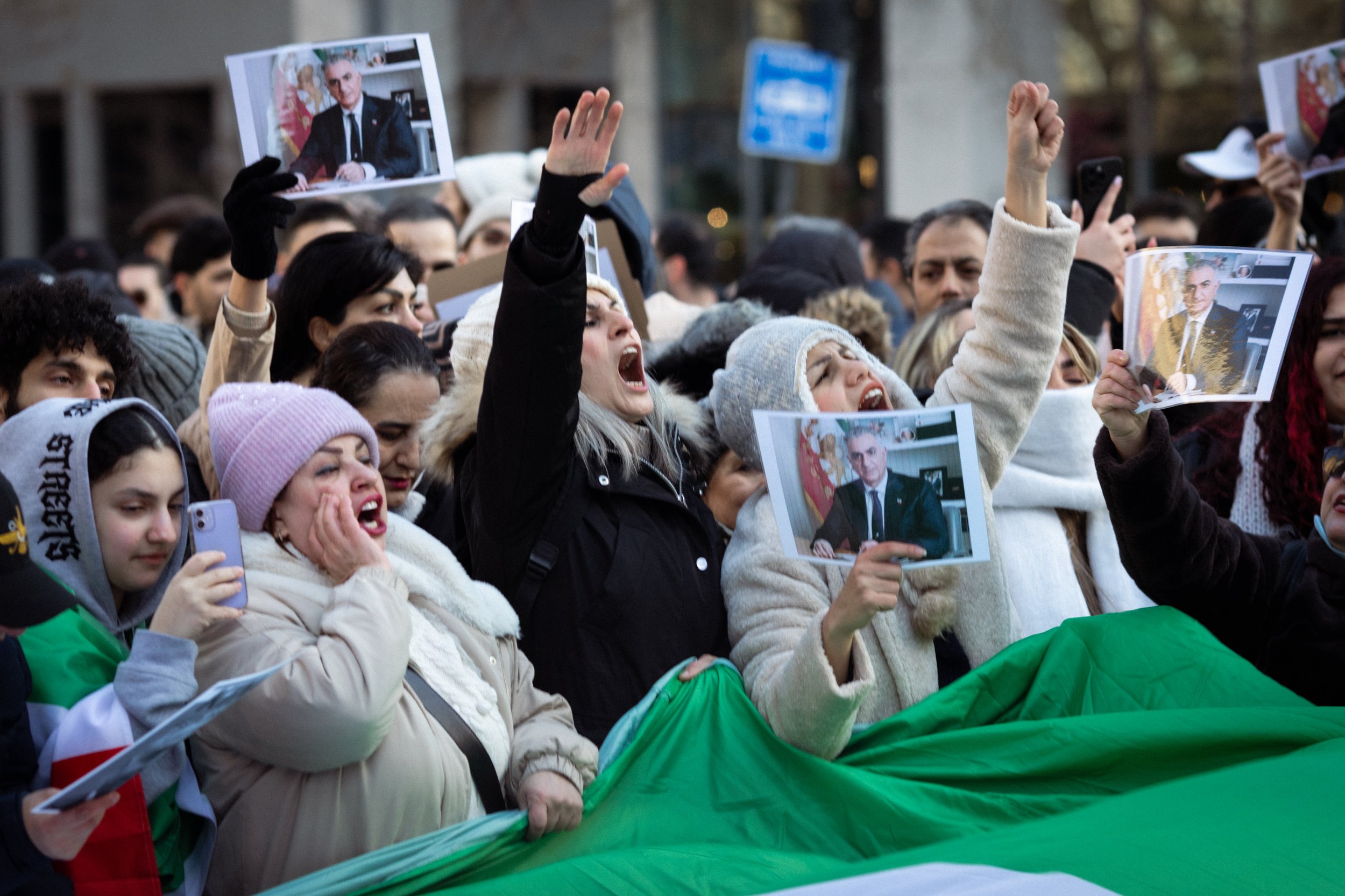 Iranian supporters holding pictures of 
Mohammad Reza Pahlavi gathered in St Peter's Square. 