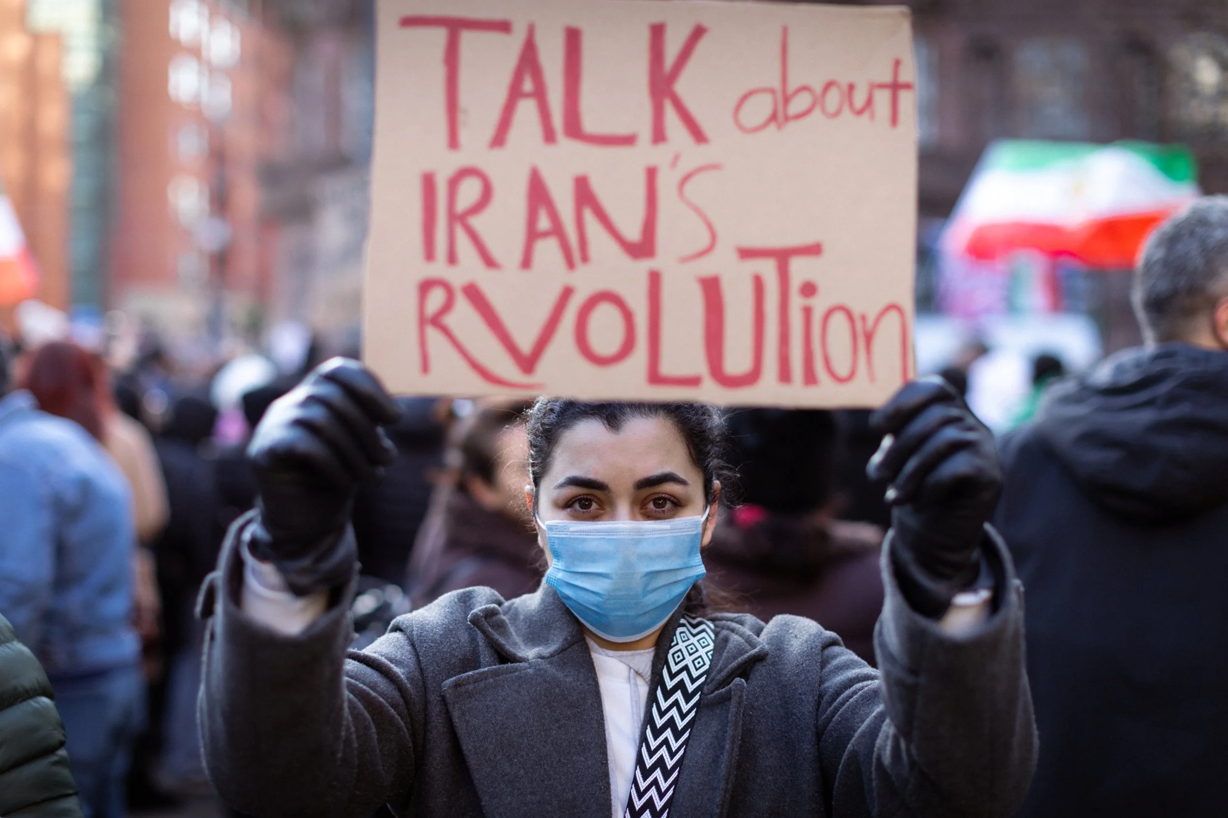 An Iranian supporter holds a placard at a demonstration against the Iranian government. 
