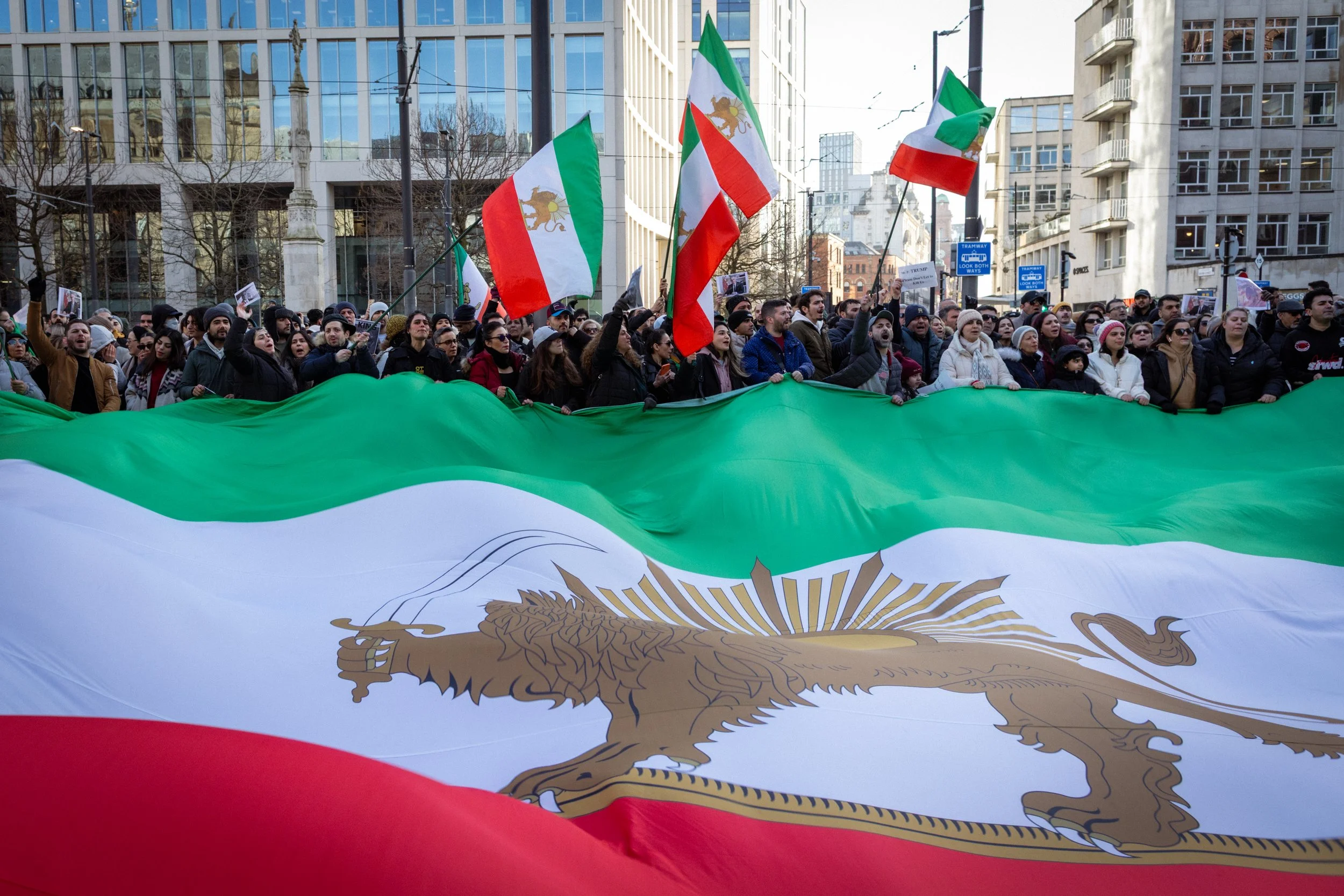Iranian supporters gather in front of a large Iranian flag in St Peter's Square. 
