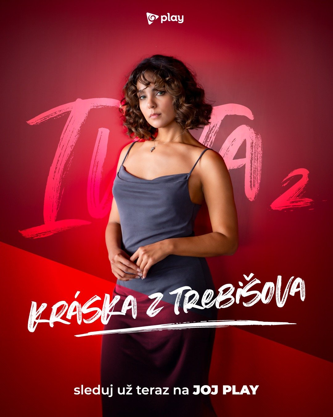 A woman standing in front of a red background with large pink text and smaller white text promoting the TV series 'Kráska z Trójsova' on JOJ Play.