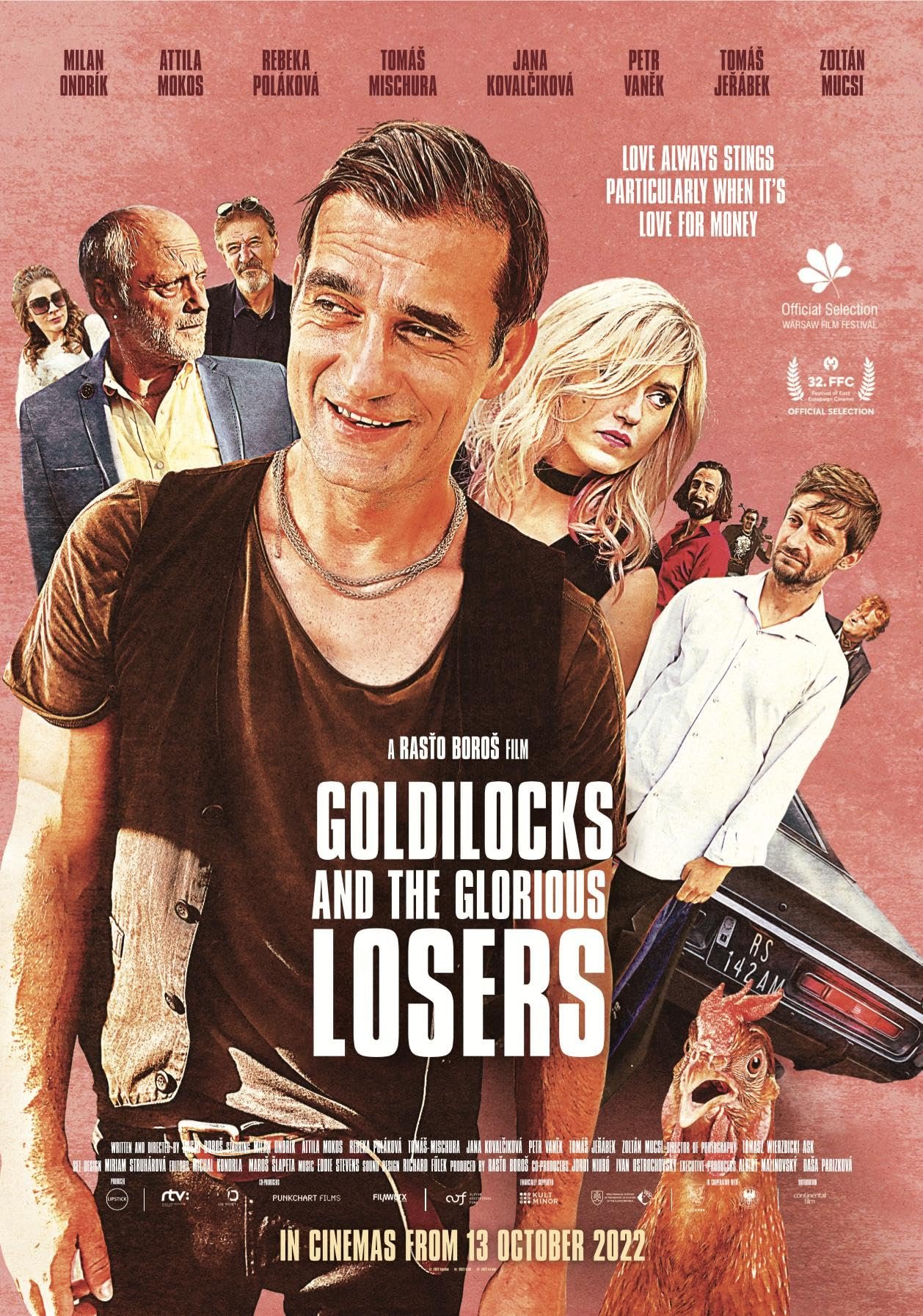 Poster for the film "Goldilocks and the Glorious Losers" featuring images of several actors, a woman with blonde hair, a man with dark hair smiling, an older man with a beard, and a dog, against a pink background with film festival awards and release date October 13, 2022.