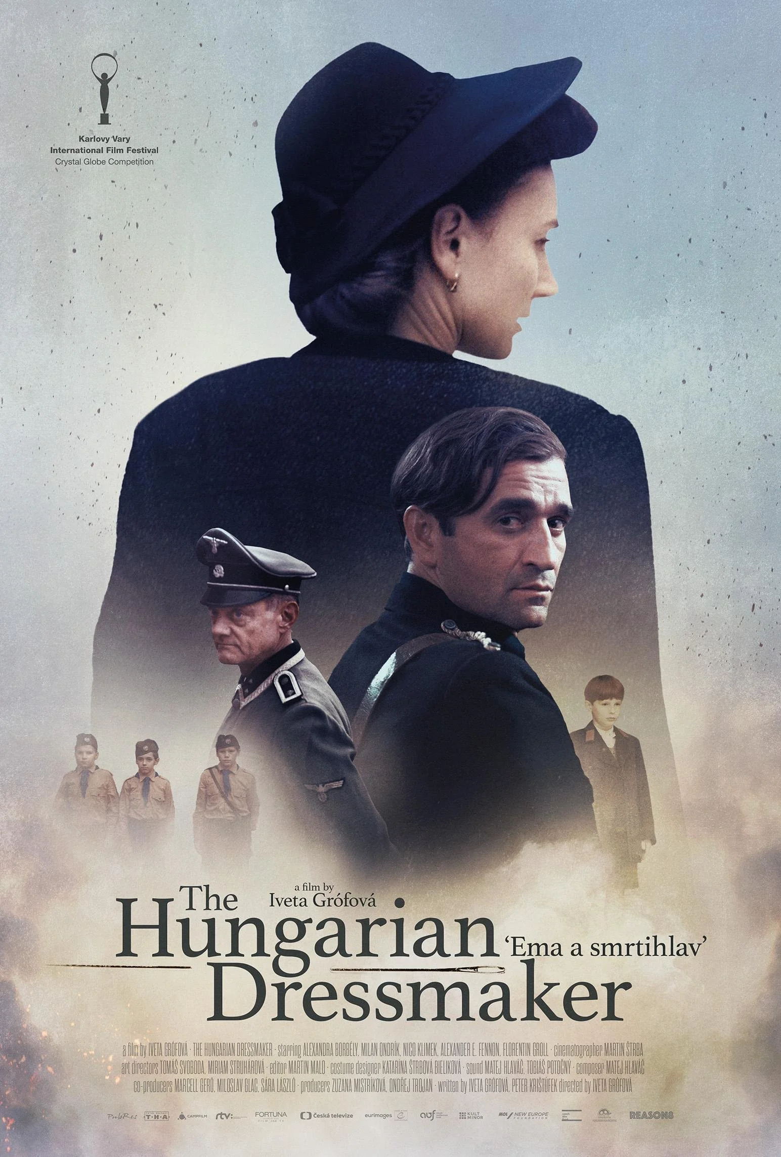 Movie poster for 'The Hungarian Dressmaker' featuring a woman in a black hat and coat, a man in a military uniform, and a group of children in scout uniforms.